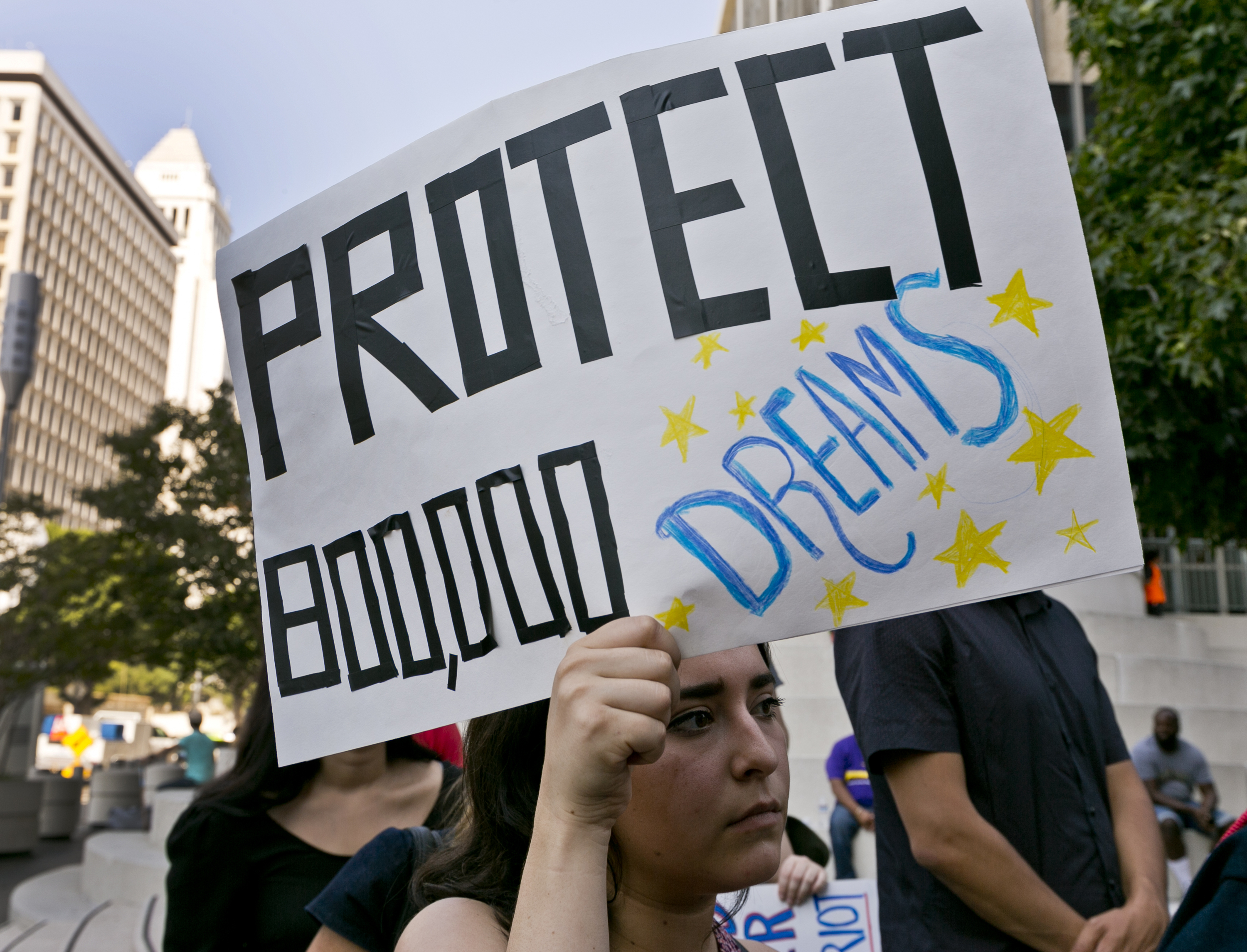 An unidentified student joins a rally in support of the Deferred Action for Childhood Arrivals, or DACA program outside the Edward Roybal Federal Building in downtown Los Angeles Friday, Sept. 1, 2017. President Donald Trump says he'll be announcing a decision on the fate of hundreds of thousands of young immigrants who were brought into the country illegally as children in the coming days, immigrants he's calling "terrific" and says he loves. Trump told reporters Friday, using a short-hand term for the nearly 800,000 young people who were given a reprieve from deportation and temporary work permits under the Obama-era DACA, program. (Credit: AP Photo/Damian Dovarganes)
