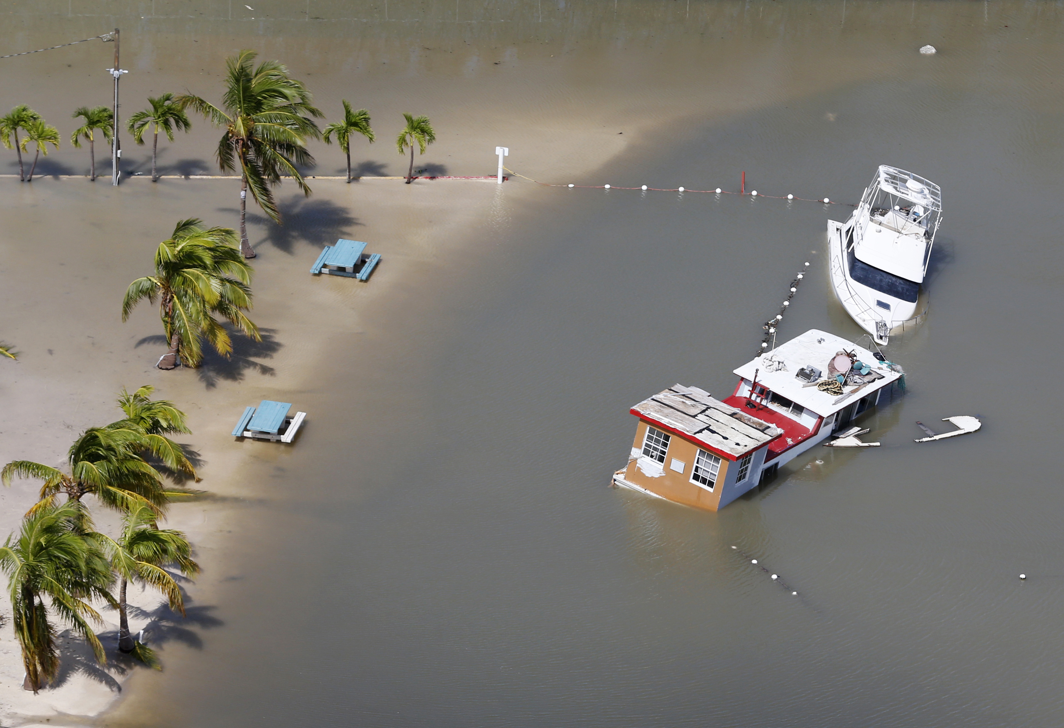 Boats are partially submerged in the wake of Hurricane Irma, Monday, Sept. 11, 2017, in Key Largo, Fla. CREDIT: AP Photo/Wilfredo Lee