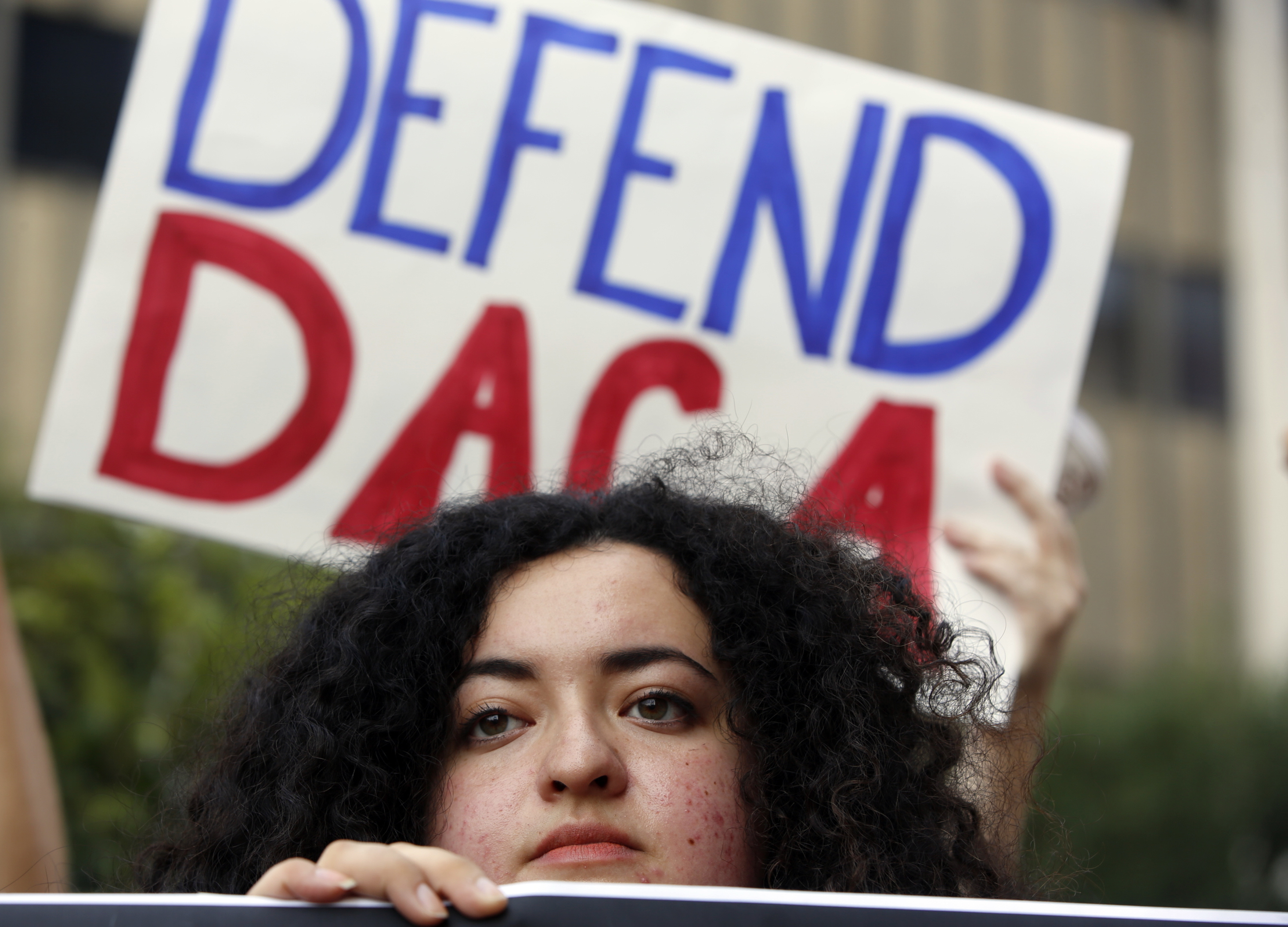 In this Sept. 1, 2017 file photo, Loyola Marymount University student and dreamer Maria Carolina Gomez joins a rally in support of the Deferred Action for Childhood Arrivals, or DACA program, outside the Edward Roybal Federal Building in Los Angeles. CREDIT: AP Photo/Damian Dovarganes, File
