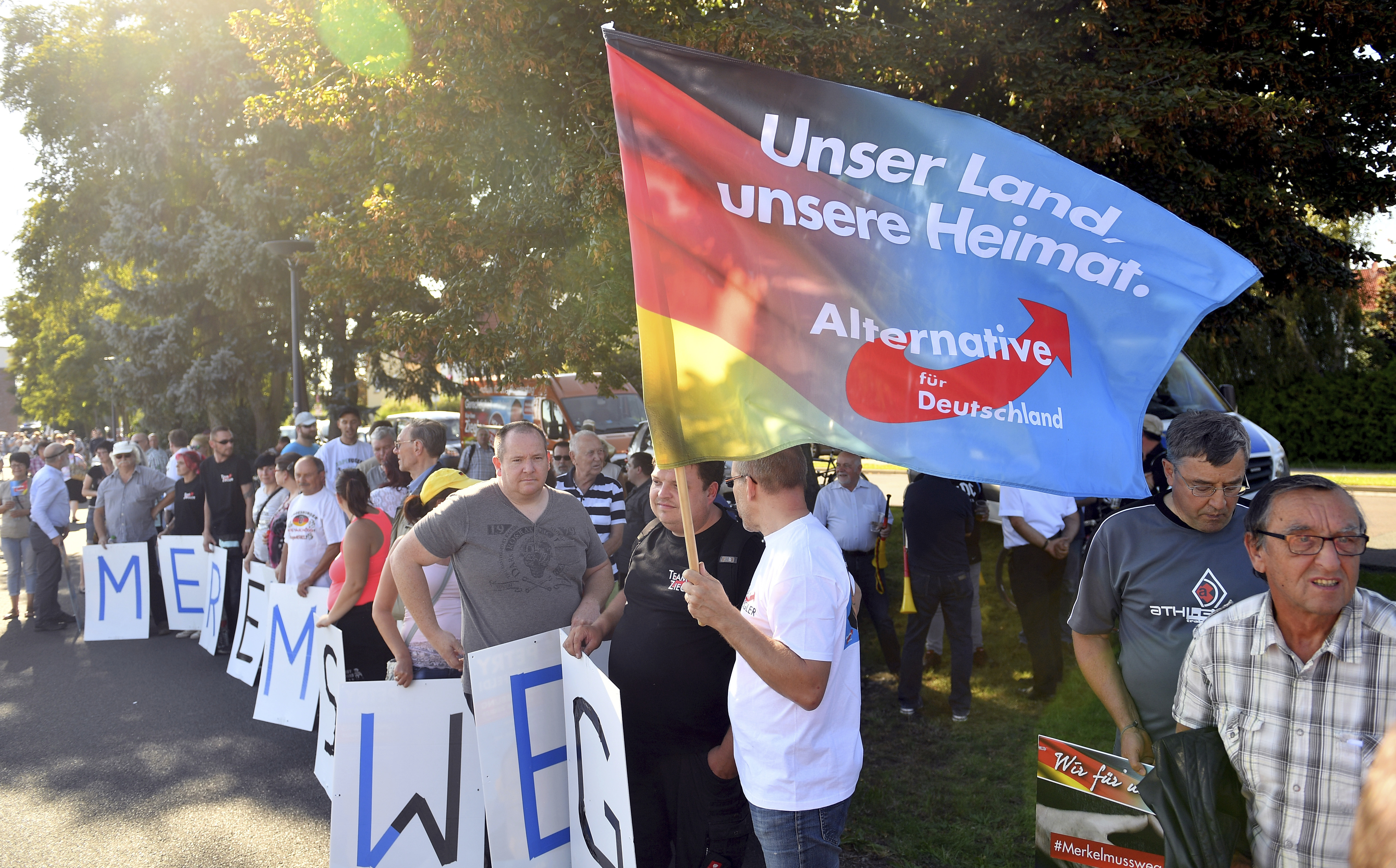 Alternative for Germany supporters protest German Chancellor Angela Merkel. (CREDIT: Hendrik Schmidt/dpa via AP)