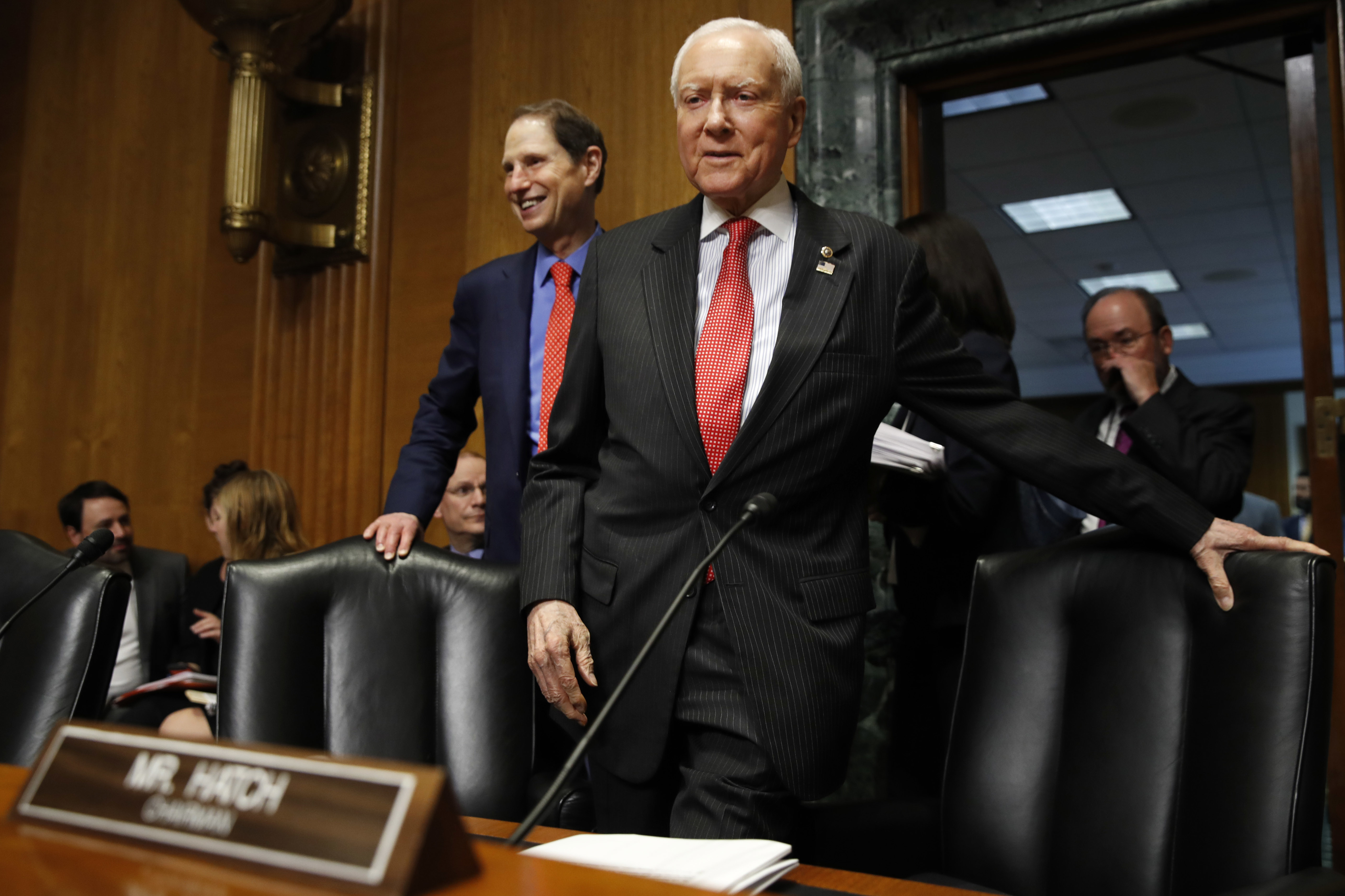 Senate Finance Committee Chairman Orrin Hatch, R-Utah, center, and ranking member Ron Wyden, D-Ore., left, arrive for a committee hearing. (AP Photo/Jacquelyn Martin)