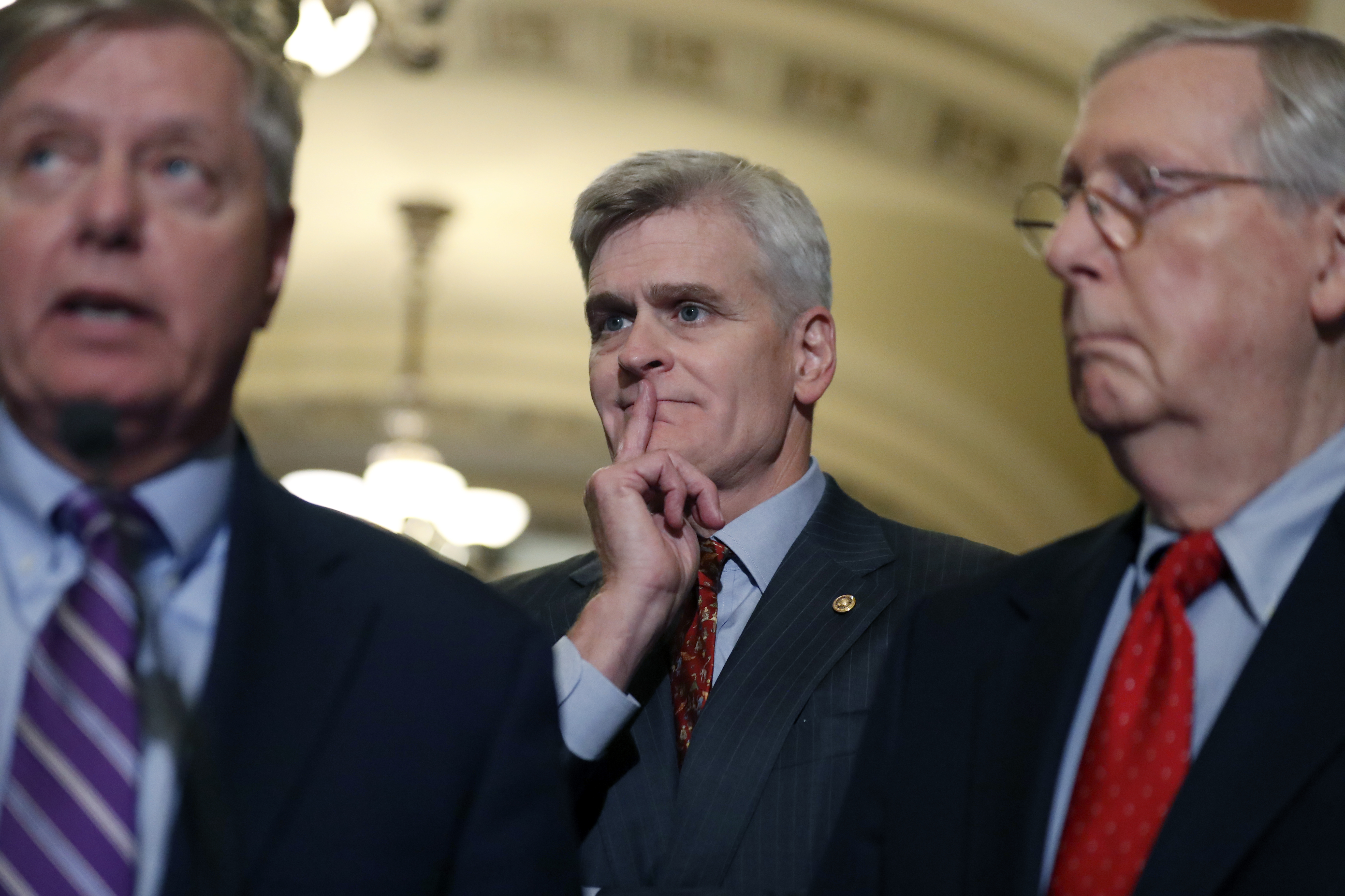 Sen. Bill Cassidy, R-La., center, listens as Sen. Lindsey Graham, R-S.C., left, speaks, accompanied by Senate Majority Leader Mitch McConnell of Ky., on Capitol Hill, Tuesday, Sept. 19, 2017 in Washington. CREDIT: AP Photo/Alex Brandon
