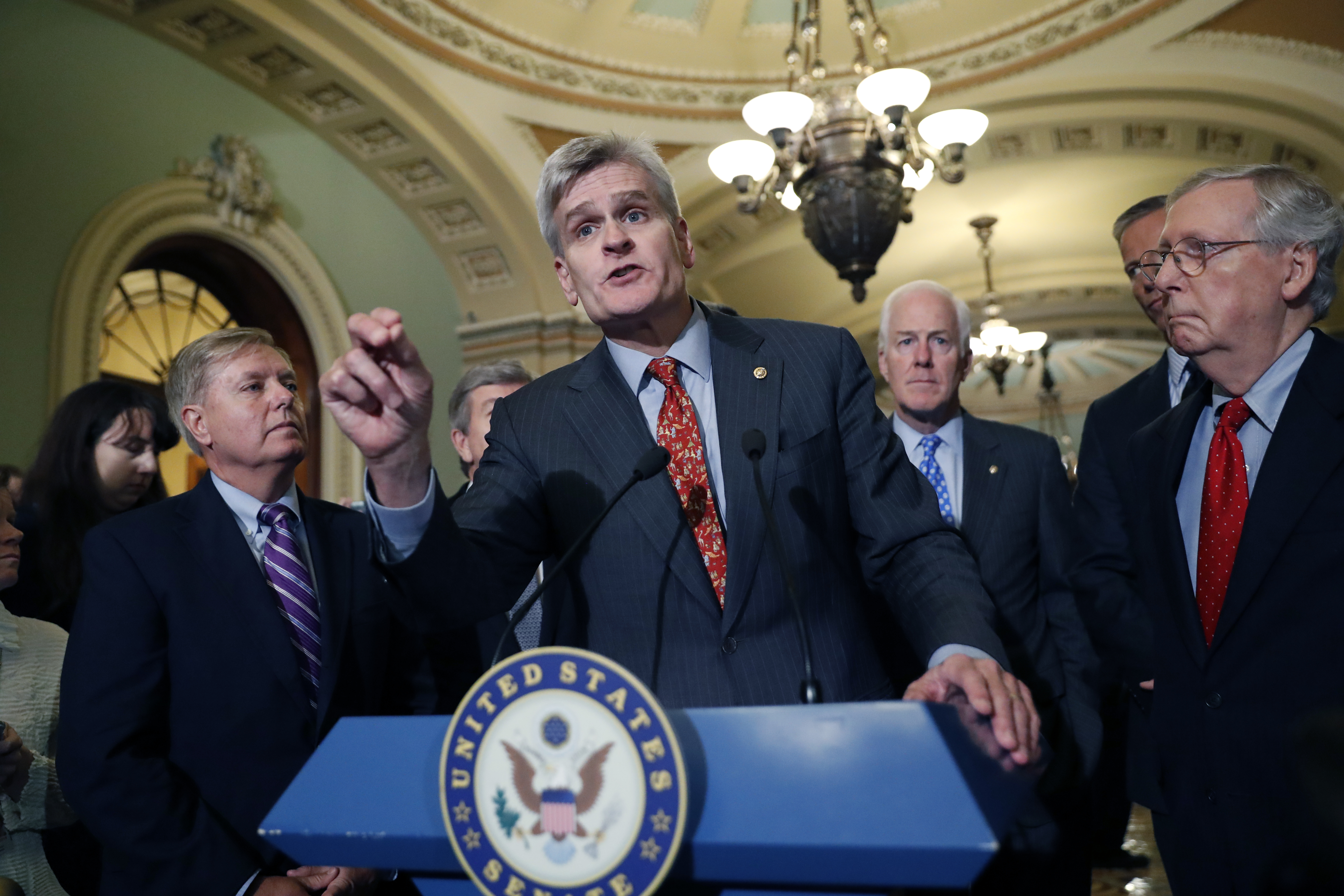 Sen. Bill Cassidy, R-La., center, speaks to the media, accompanied by Sen. John Cornyn, R-Texas, and Senate Majority Leader Mitch McConnell of Ky., on Capitol Hill, Tuesday, Sept. 19, 2017 in Washington. (AP Photo/Alex Brandon)