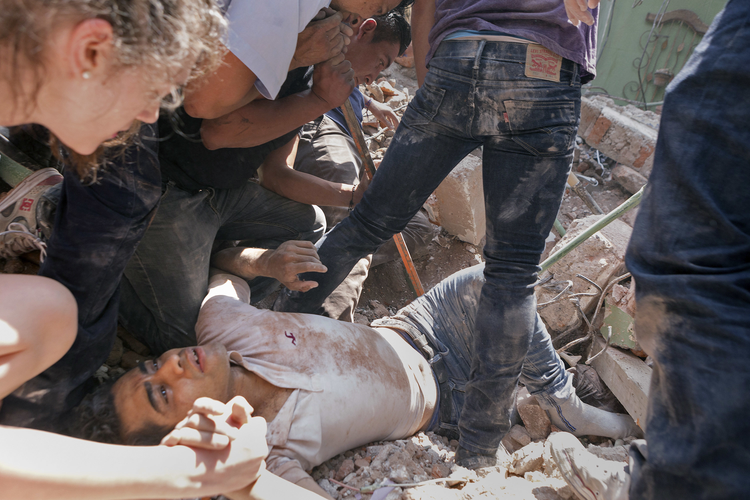 In this September 19, 2017 photo, a man is rescued from a collapsed building in the Condesa neighborhood after an earthquake struck Mexico City. CREDIT: AP Photo/Pablo Ramos