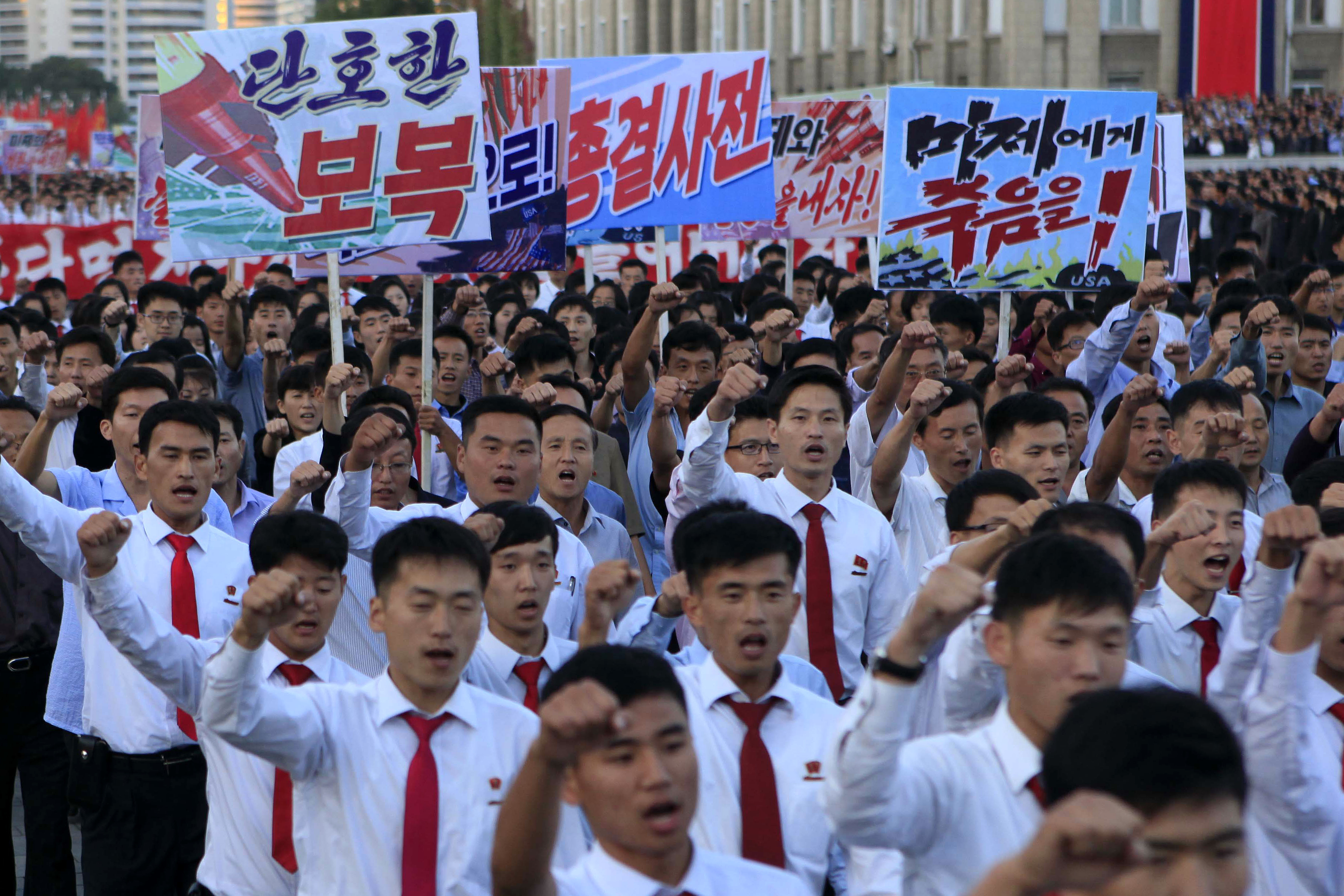 North Koreans gather at Kim Il Sung Square to attend a mass rally against America on Saturday, Sept. 23, 2017, in Pyongyang, North Korea, a day after the country's leader issued a rare statement attacking Donald Trump. The sign on the left reads "decisive revenge" and the sign on the right reads "death to the American imperialists." CREDIT: Jon Chol Jin/AP Photo