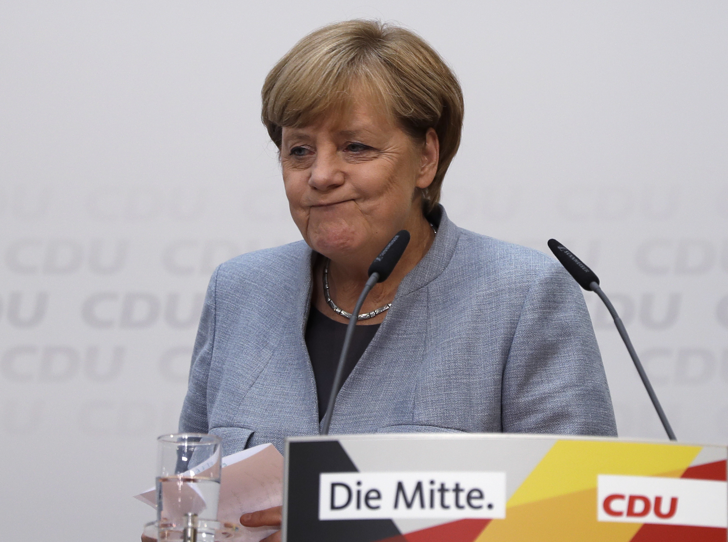 German Chancellor Angela Merkel arrives for a press conference the day after the German parliament election. (AP Photo/Matthias Schrader)