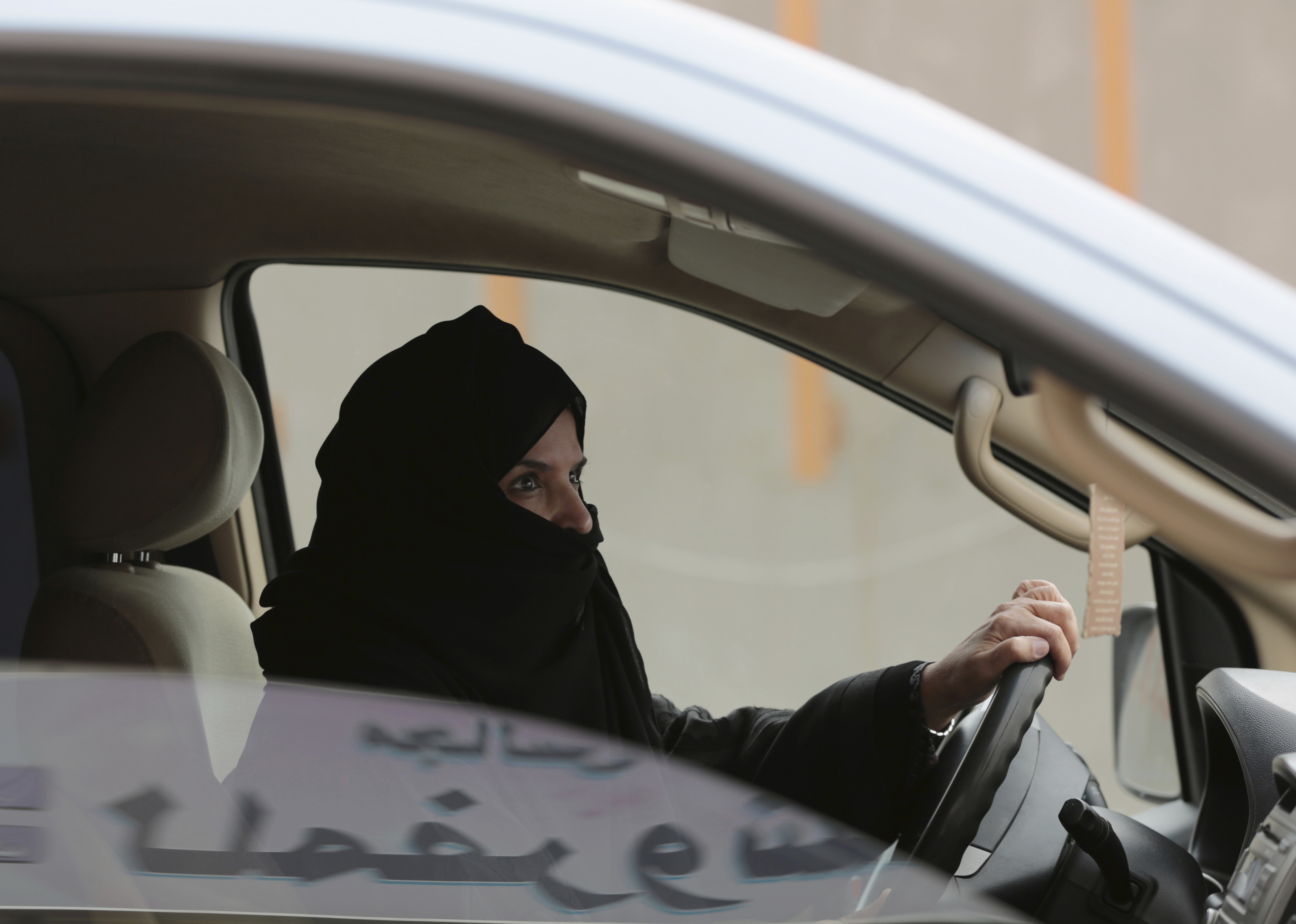 Aziza Yousef drives a car on a highway in Riyadh, Saudi Arabia, as part of a campaign to defy Saudi Arabia's ban on women driving. CREDIT: AP Photo/Hasan Jamali, File