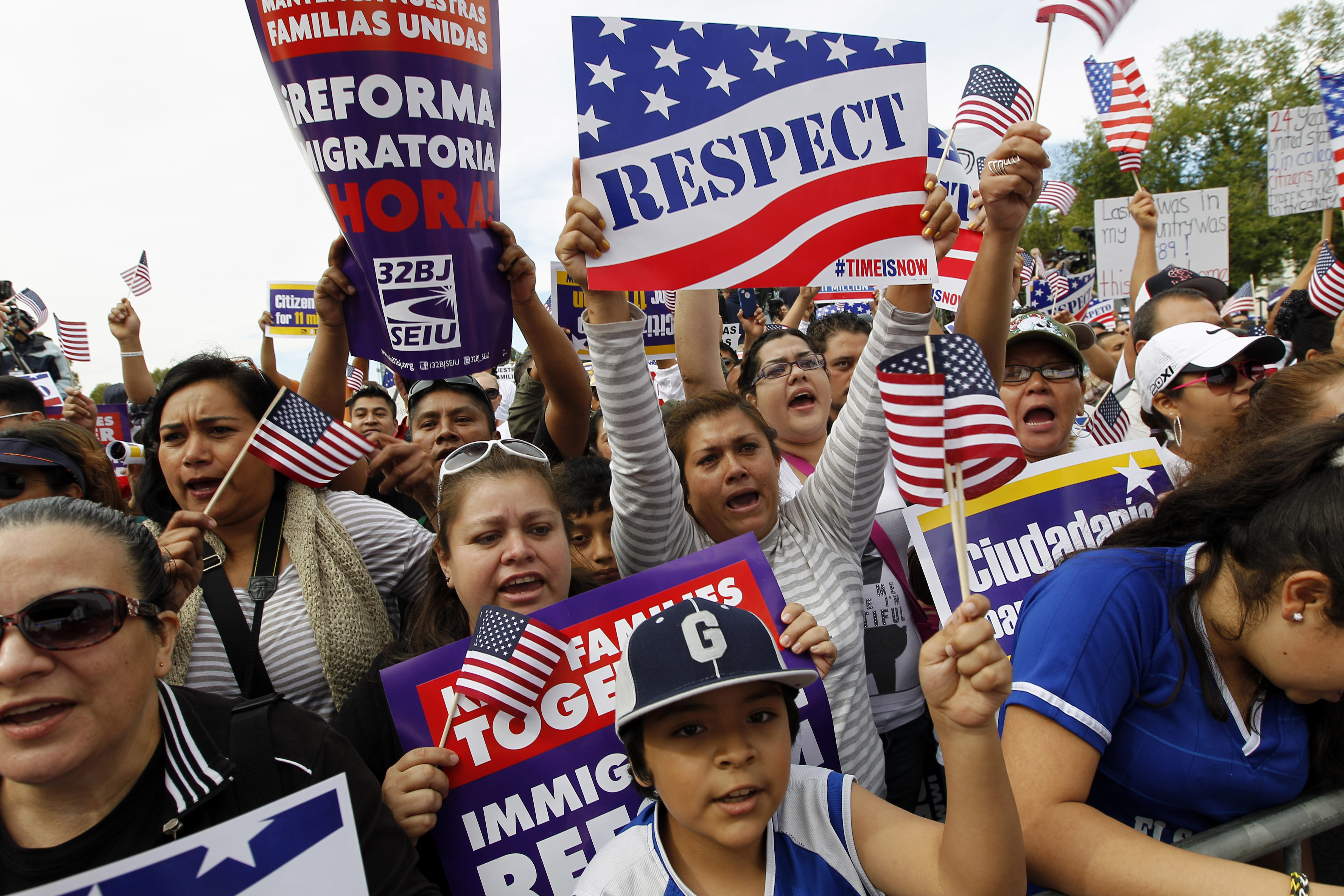Demonstrators hold up their banners as the shout during a immigration a rally on the National Mall in Washington, Oct. 8, 2013. (CREDIT: AP Photo/Jose Luis Magana)