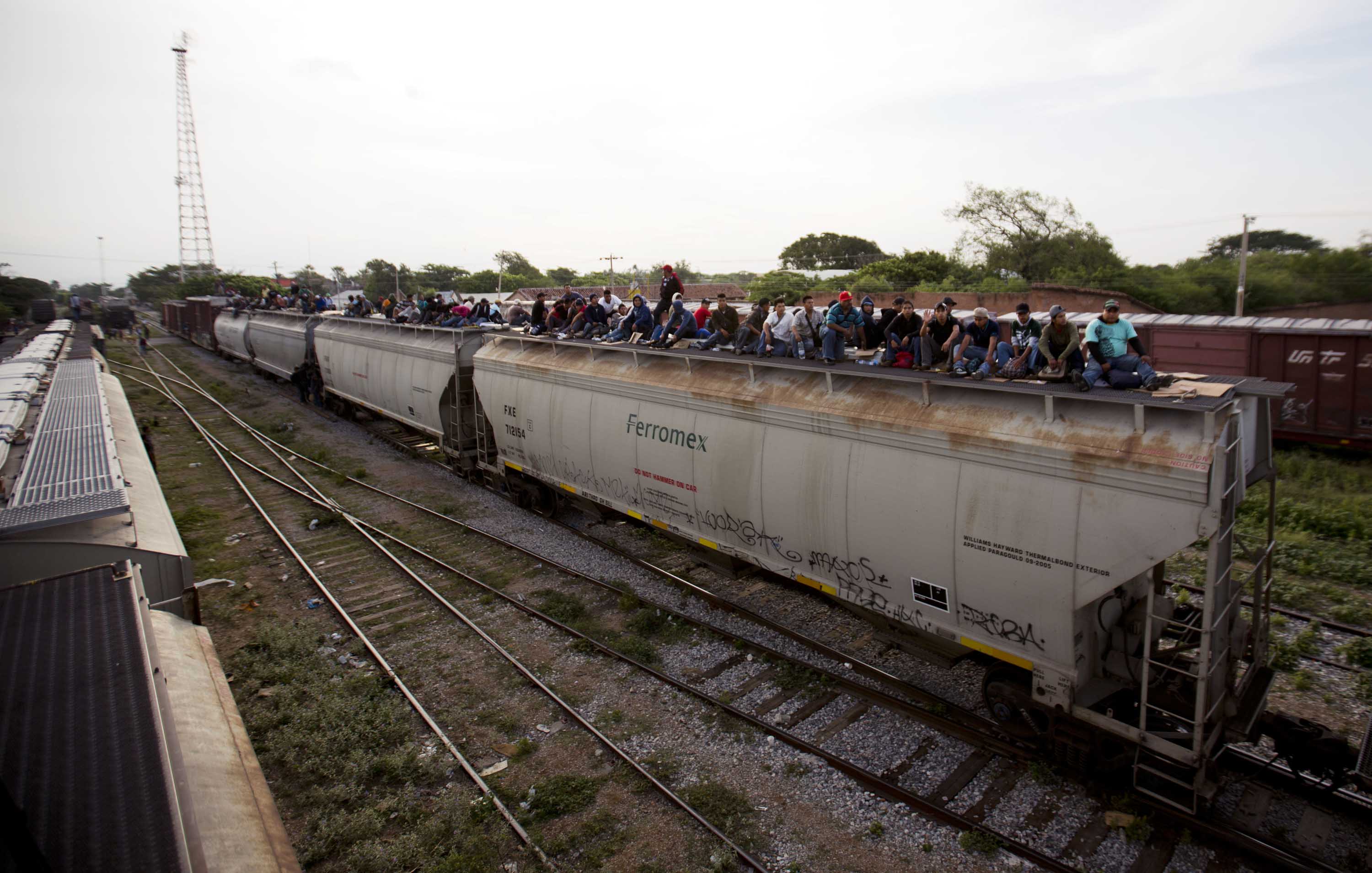 In this July 12, 2014, photo, Central American migrants ride a freight train during their journey toward the U.S.-Mexico border in Ixtepec, Mexico. Many of the children and teenagers who travelled to the United States recently said they did so after hearing they would be allowed to stay. CREDIT: AP Photo/Eduardo Verdugo