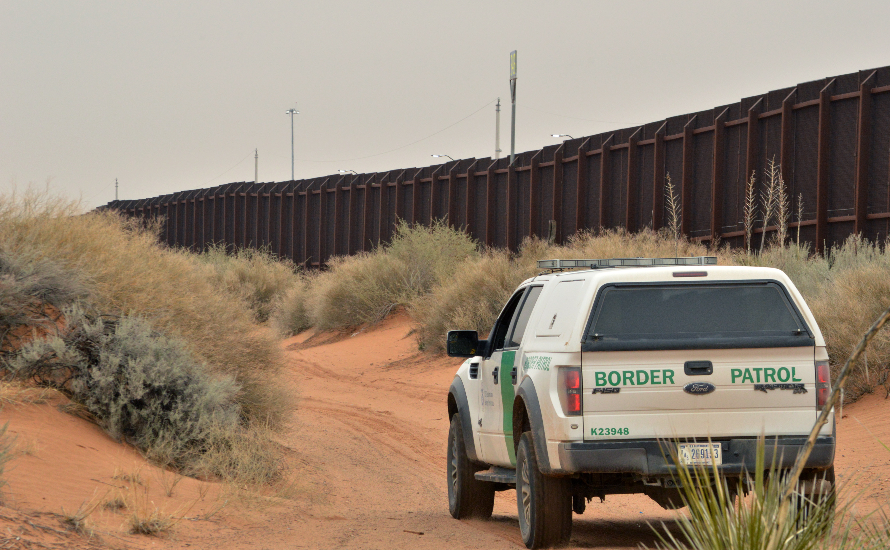 A U.S. Border Patrol agent drives near the U.S.-Mexico border fence. CREDIT: AP Photo/Russell Contreras