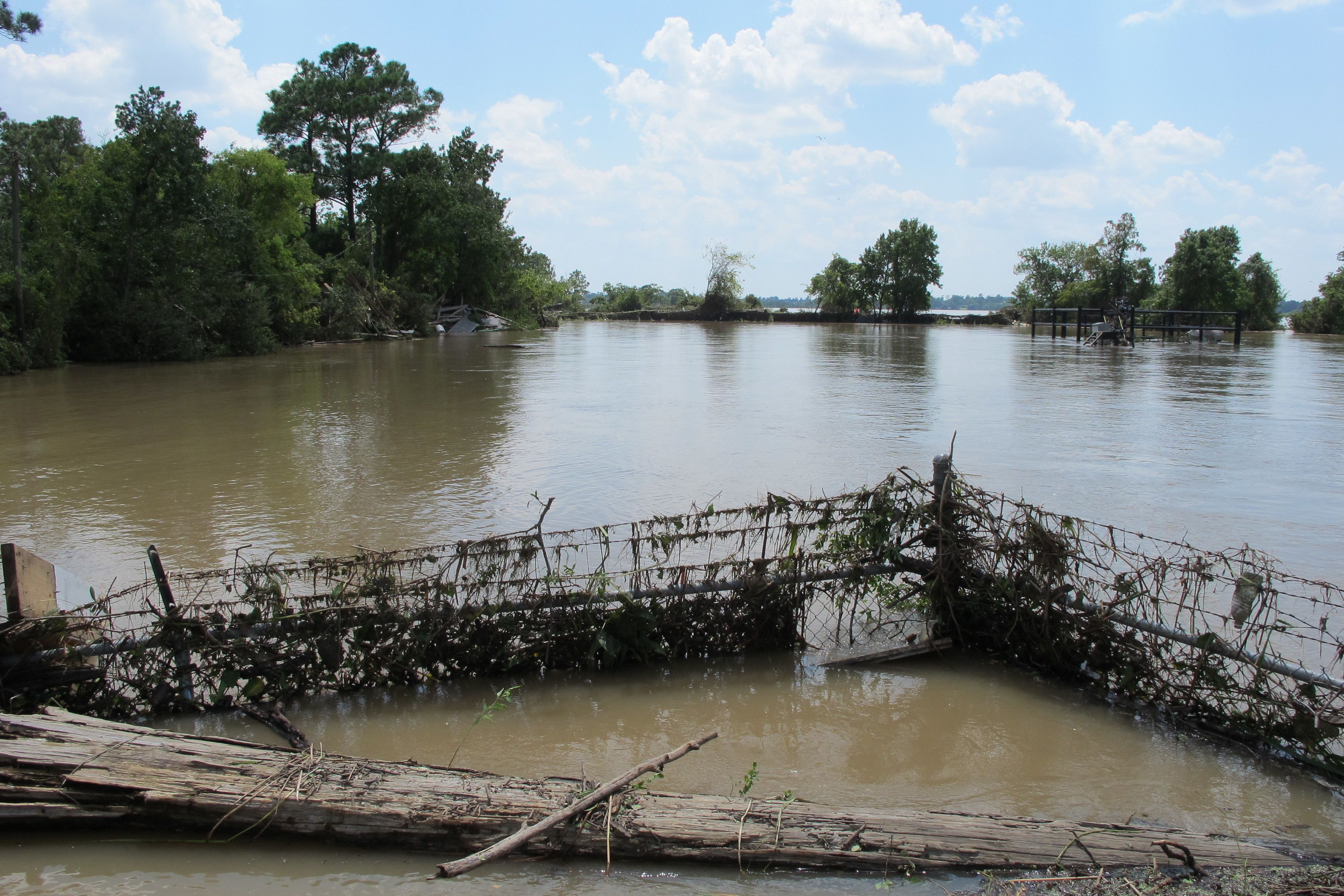 A barbed-wire fence encircles the flooded Highlands Acid Pit, located east of Houston. CREDIT: AP Photo/Jason Dearen
