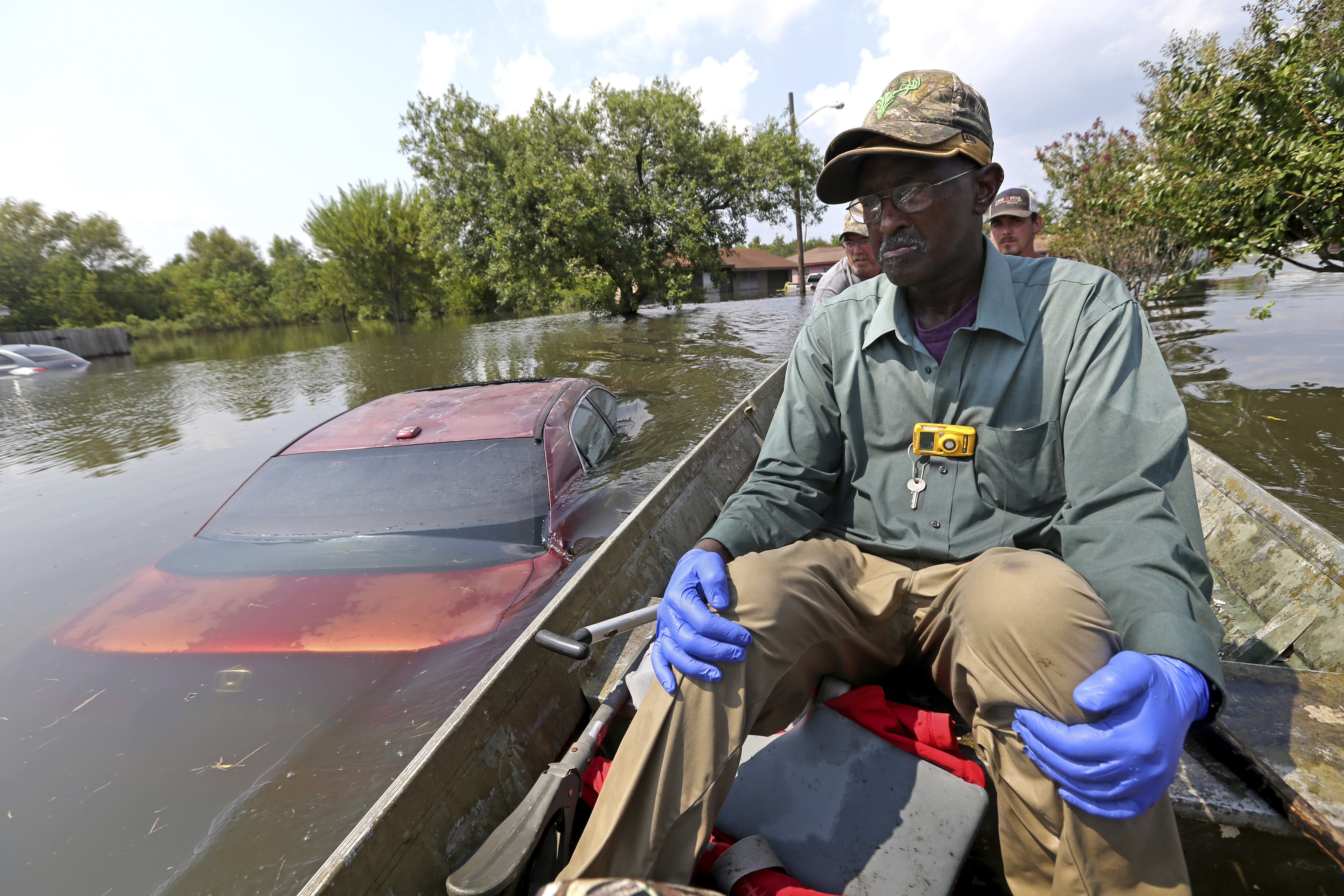 Michael Brown searches his flooded home in Port Arthur, Texas, for his wife's medicine and other belongings, in the aftermath of Hurricane Harvey. CREDIT: AP Photo/Gerald Herbert