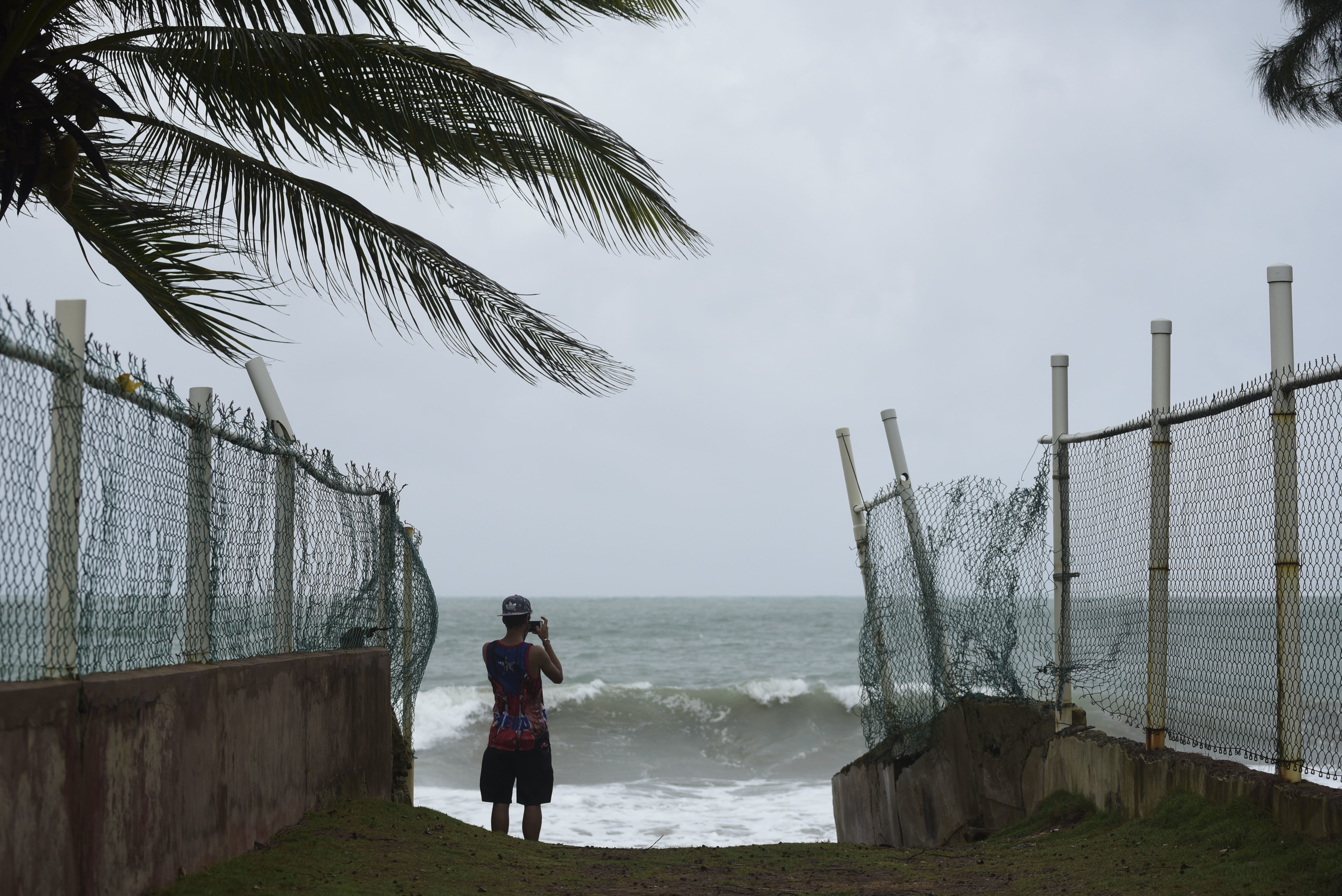 In luquillo, Puerto Rico, a resident awaits the arrival of Hurricane Irma on September 6, 2017. CREDIT: AP Photo/Carlos Giusti