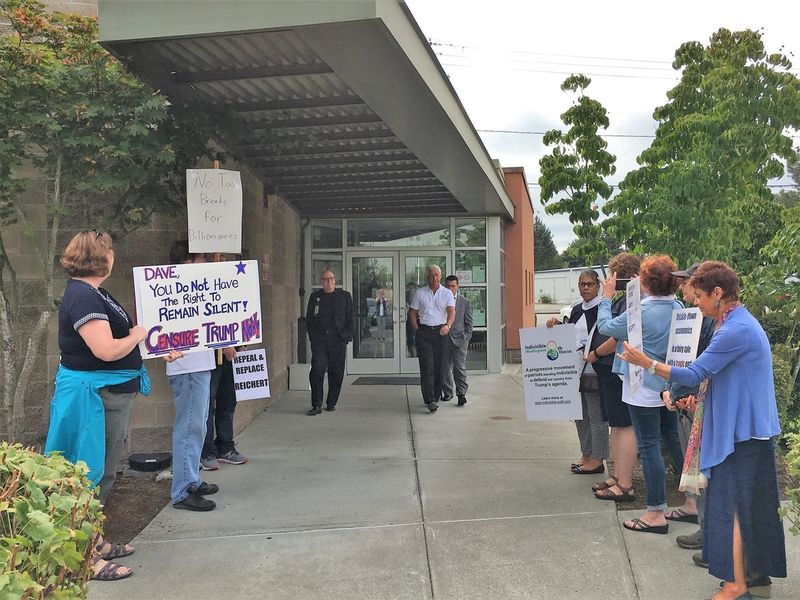 Indivisible Washington Eighth confronts Rep. Reichert at a community health center in Auburn, WA. CREDIT: Chris Petzold