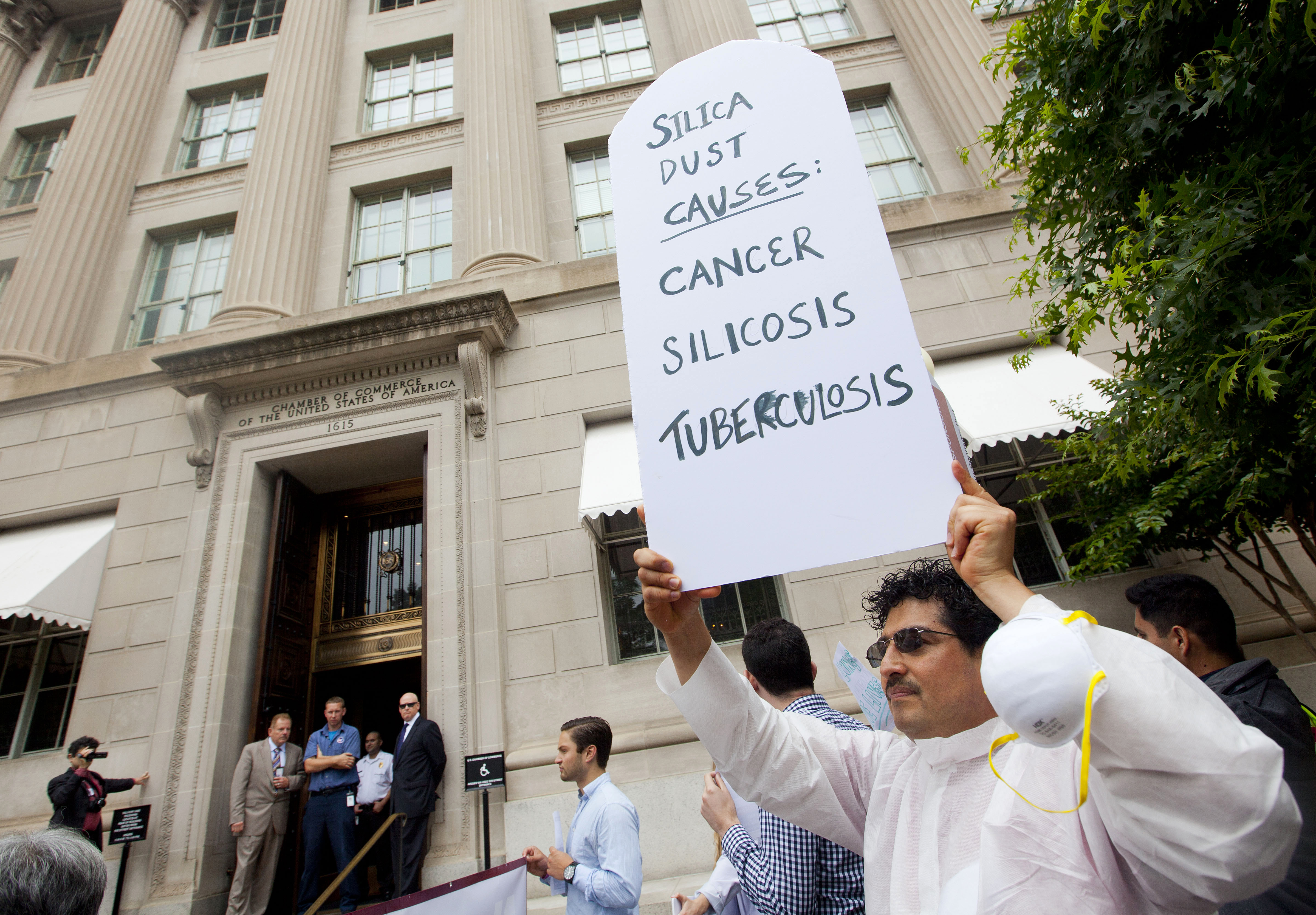 Workers protest outside the U.S. Chamber of Commerce in Washington. The Chamber of Commerce opposed OSHA's rule limiting worker exposure to silica dust. CREDIT: AP Photo/Pablo Martinez Monsivais