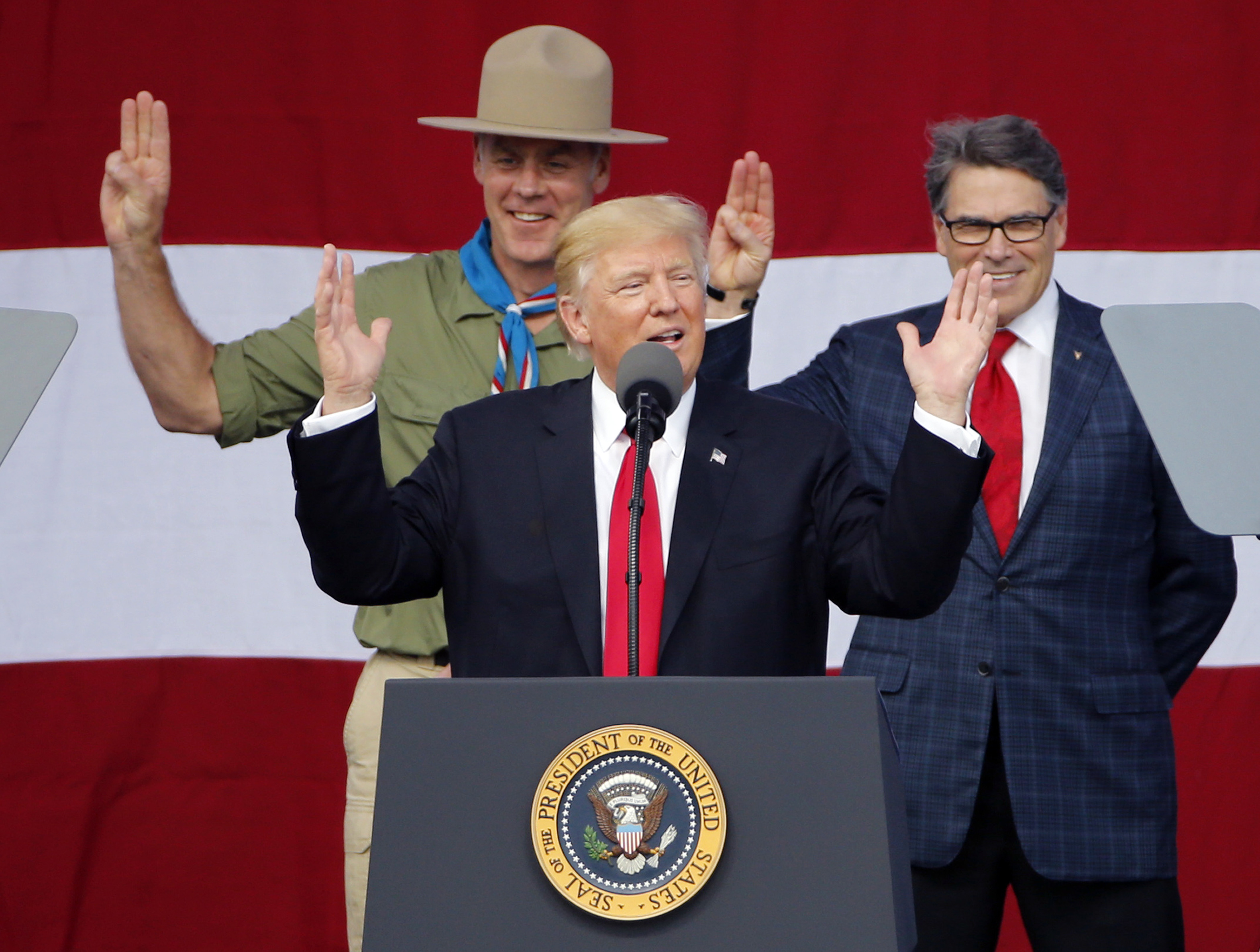 Interior Secretary Ryan Zinke and Energy Secretary Rick Perry express support for President Donald Trump's goal of drastically cutting regulations. CREDIT: AP Photo/Steve Helber