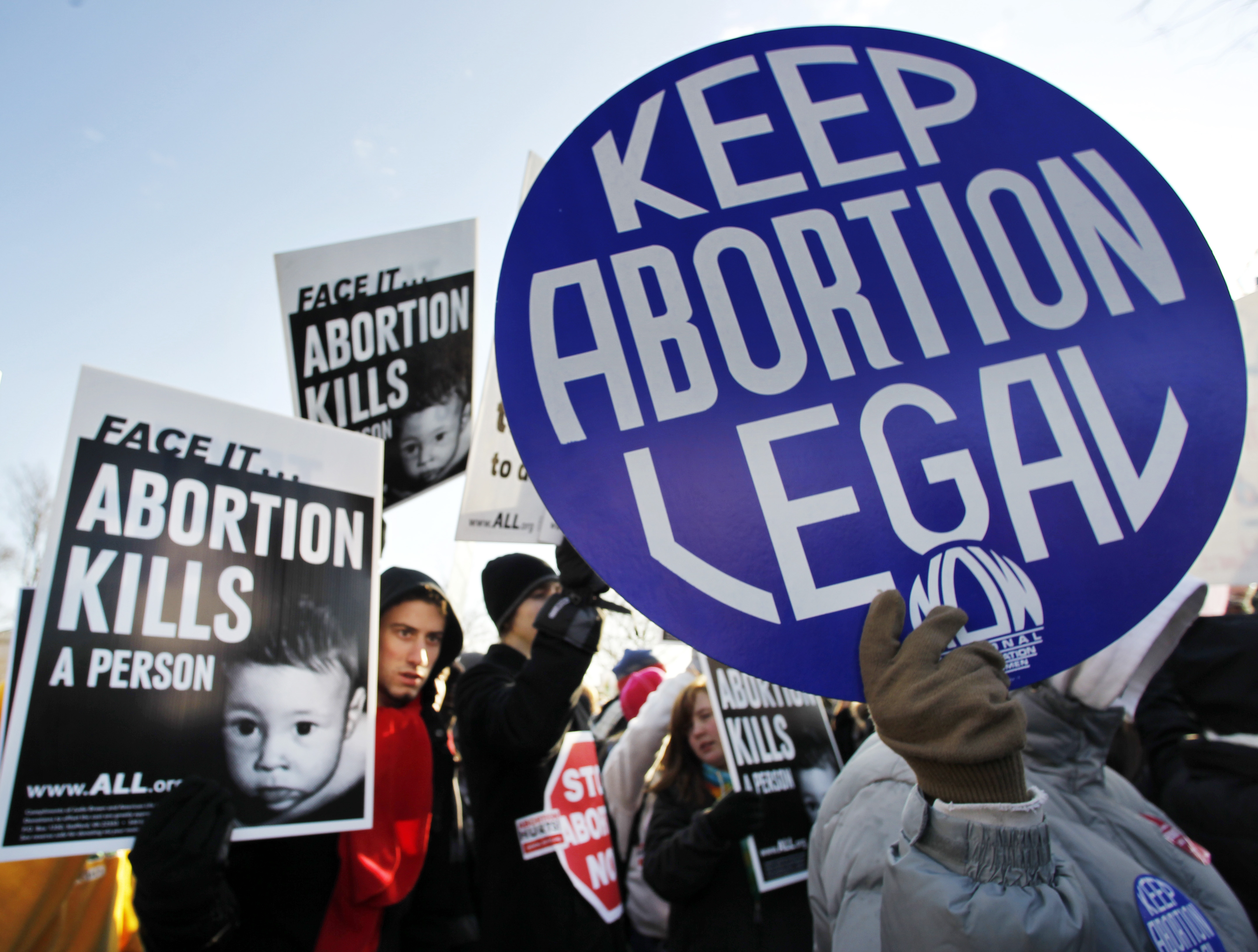 In this Monday, Jan. 24, 2011 file picture, anti-abortion and pro-choice activists stand next to each other in front of the U.S. Supreme Court in Washington during a rally on the anniversary of the Roe v. Wade decision. CREDIT: AP Photo/Manuel Balce Ceneta