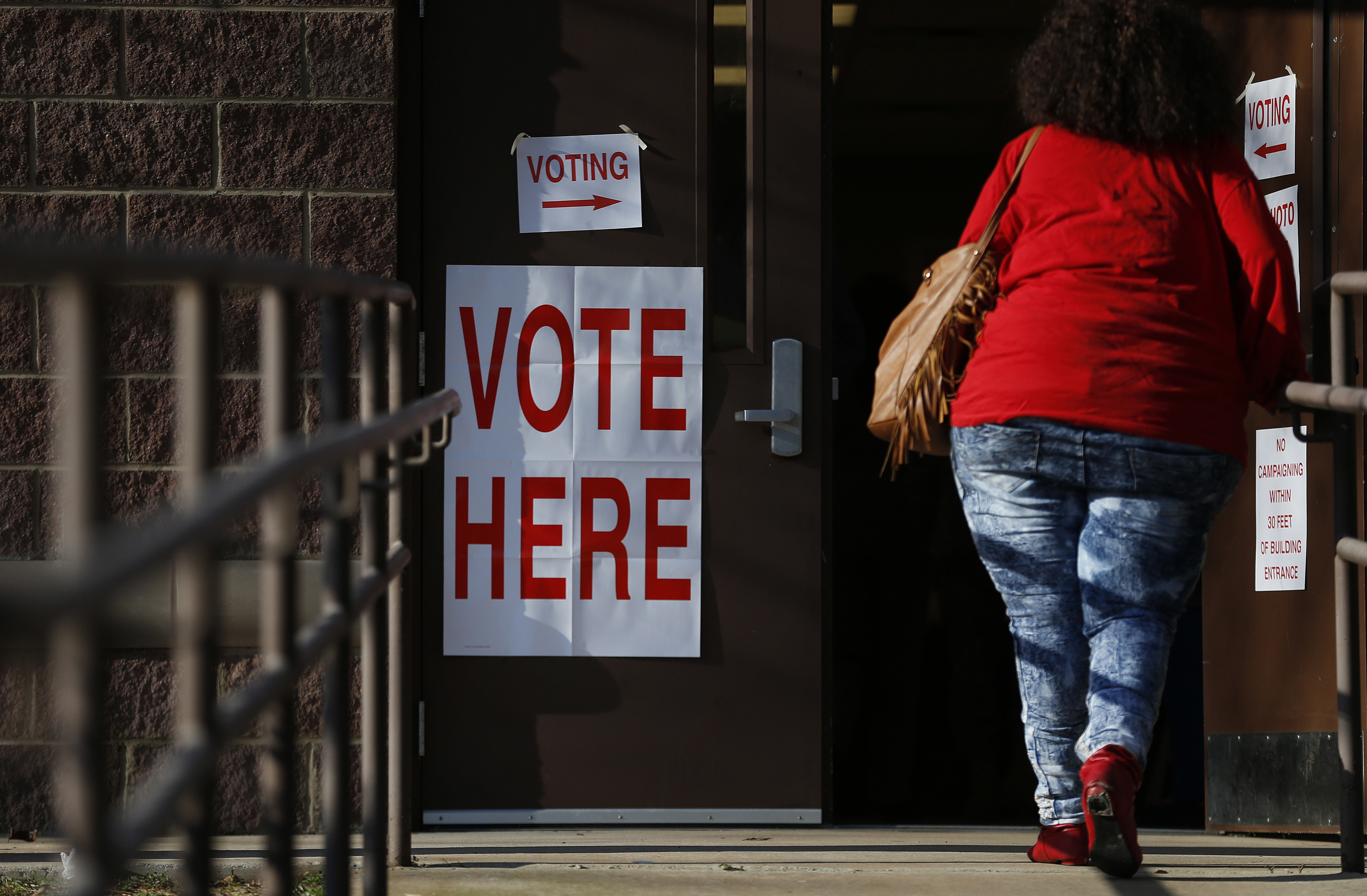 A voter walks in to cast her ballot during Alabama's primary at a polling site, Tuesday, March 1, 2016, in Birmingham, Ala. CREDIT: AP Photo/Brynn Anderson