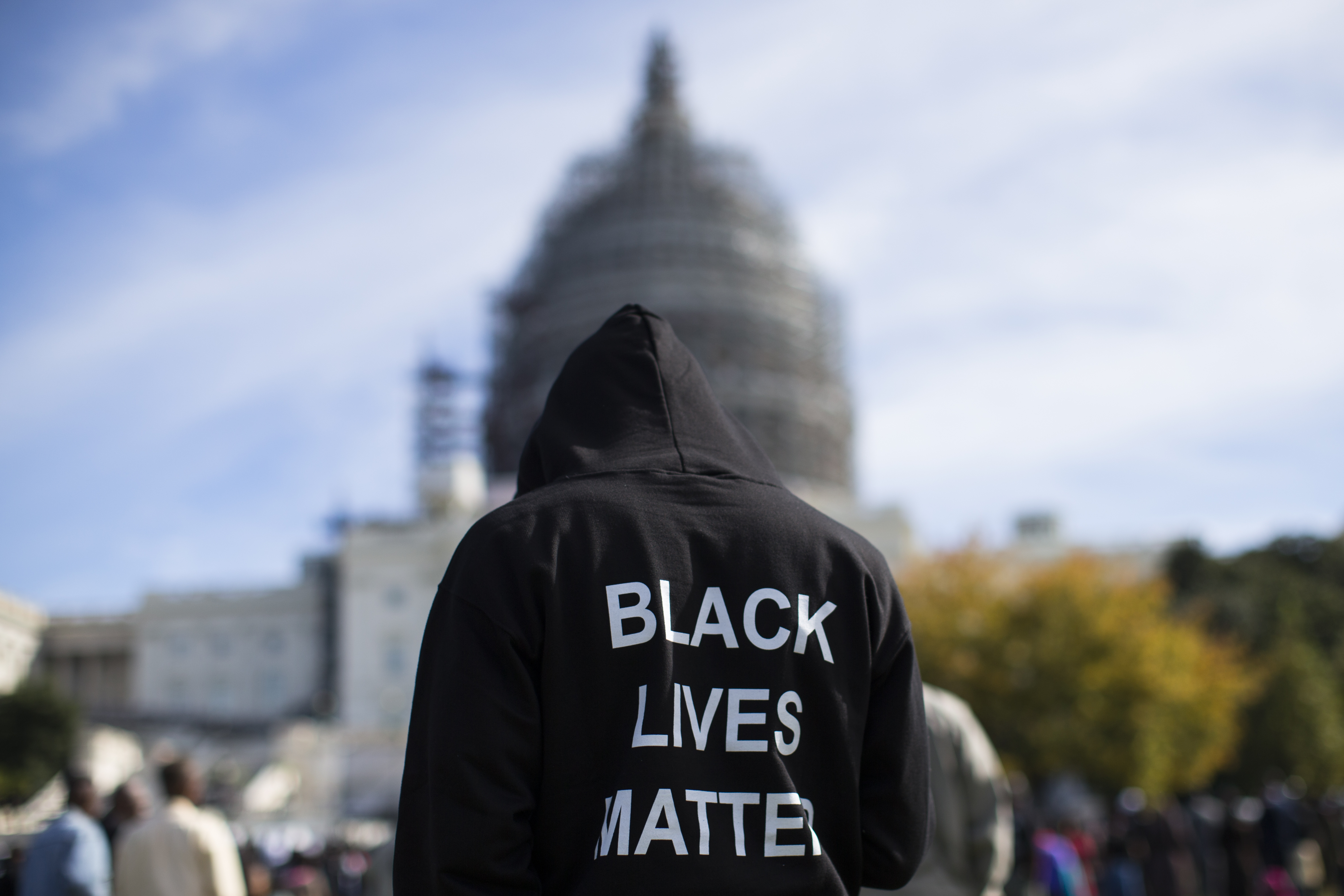 A man wears a "Black Lives Matter" hoodie as he stands on the lawn of the Capitol building. CREDIT: AP Photo/Evan Vucci, File