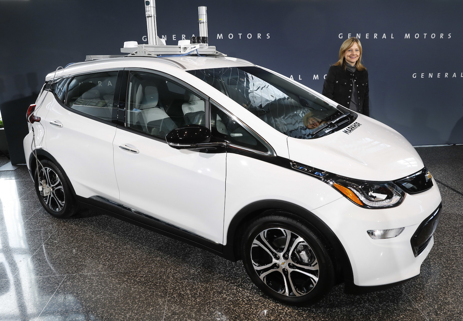 GM CEO Mary Barra and an autonomous Chevrolet Bolt electric car, 2-15-16. CREDIT: AP/Paul Sancya.