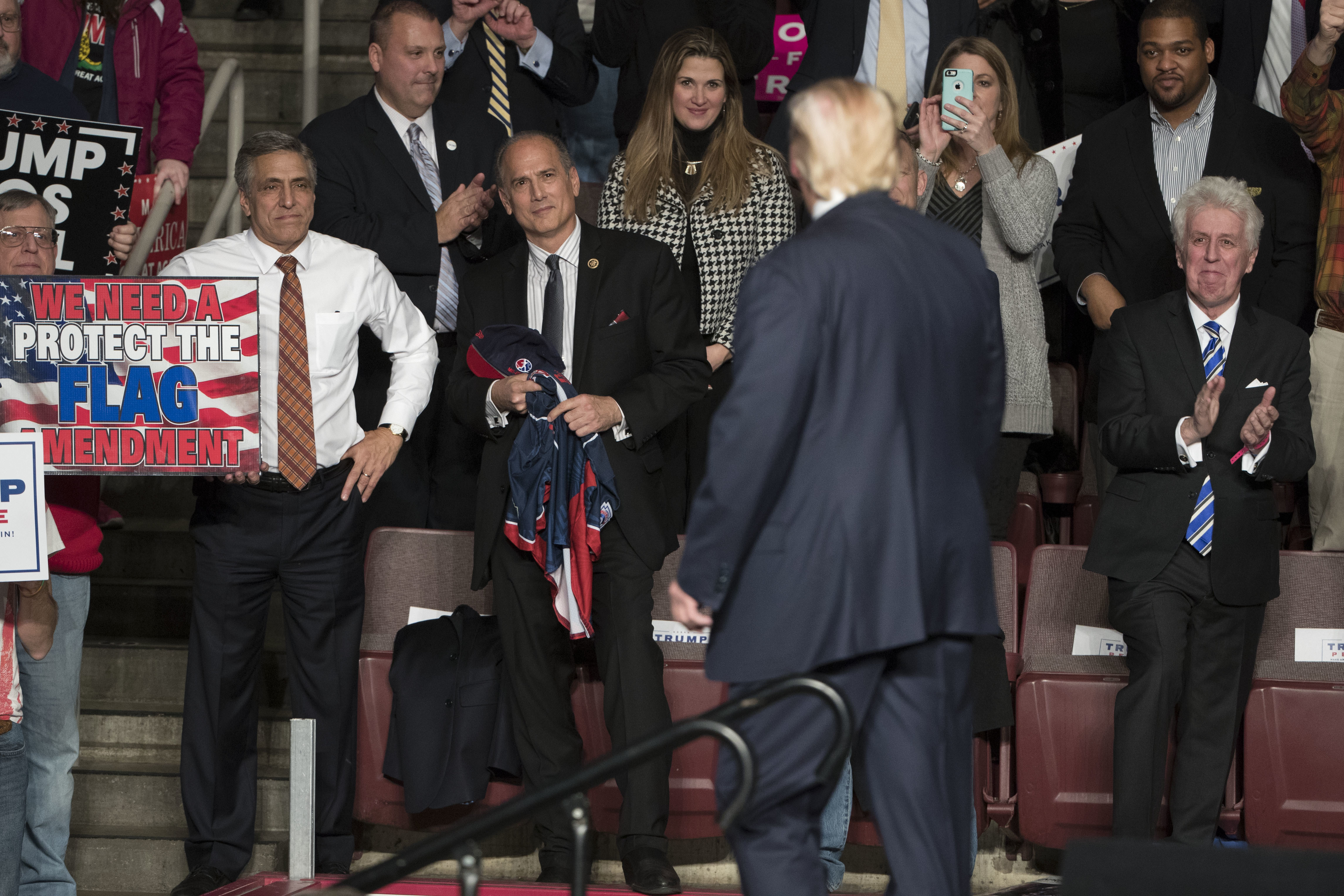 Tom Marino (R-PA), center, watches as President-elect Donald Trump, center right, departs a rally. CREDIT: AP Photo/Matt Rourke