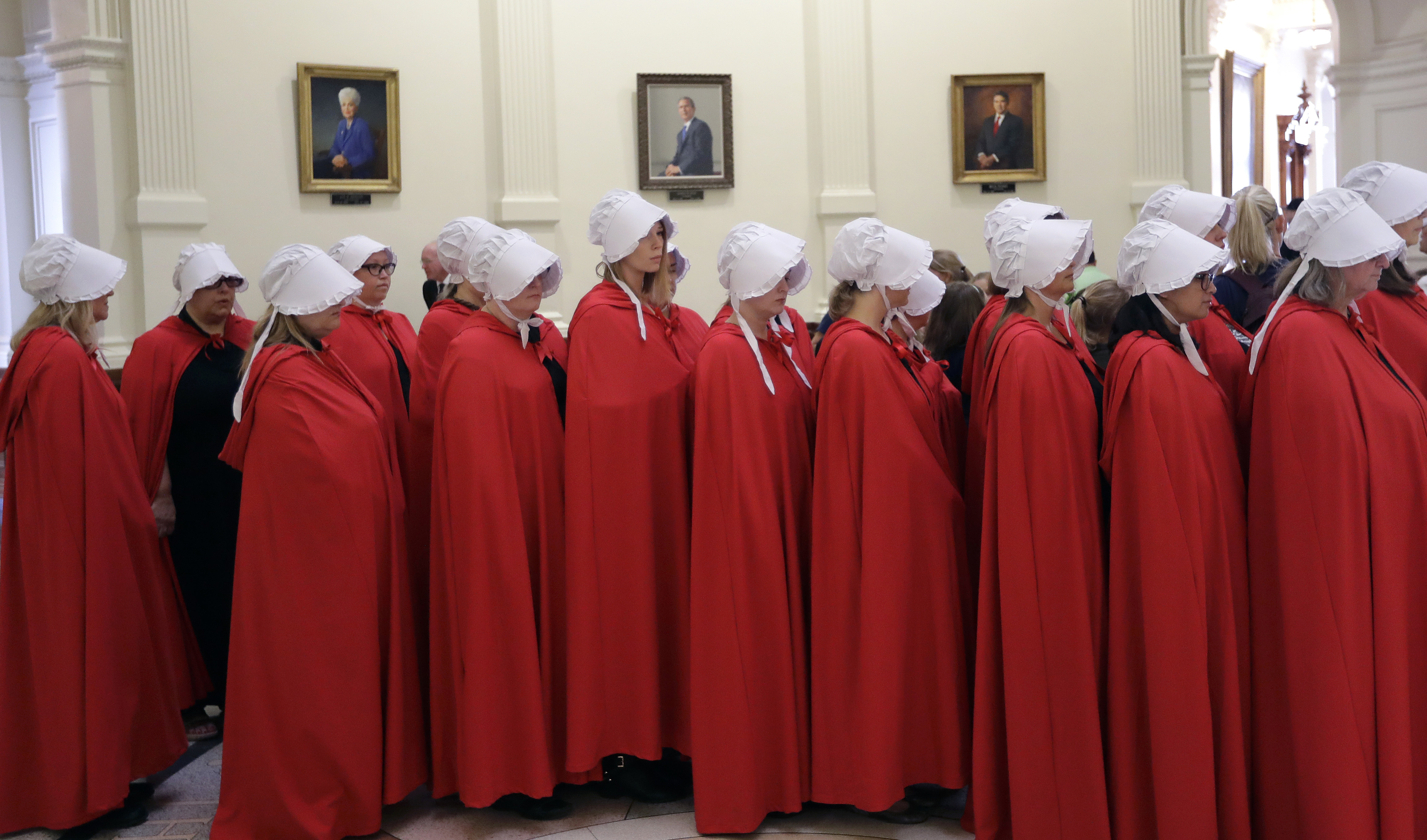 Activists dressed as characters from "The Handmaid's Tale" gather in the Texas Capitol Rotunda as they protest SB8, a bill that would require health care facilities, including hospitals and abortion clinics, to bury or cremate any fetal remains whether from abortion, miscarriage or stillbirth, and they would be banned from donating aborted fetal tissue to medical researchers, Tuesday, May 23, 2017, in Austin. CREDIT: AP Photo/Eric Gay