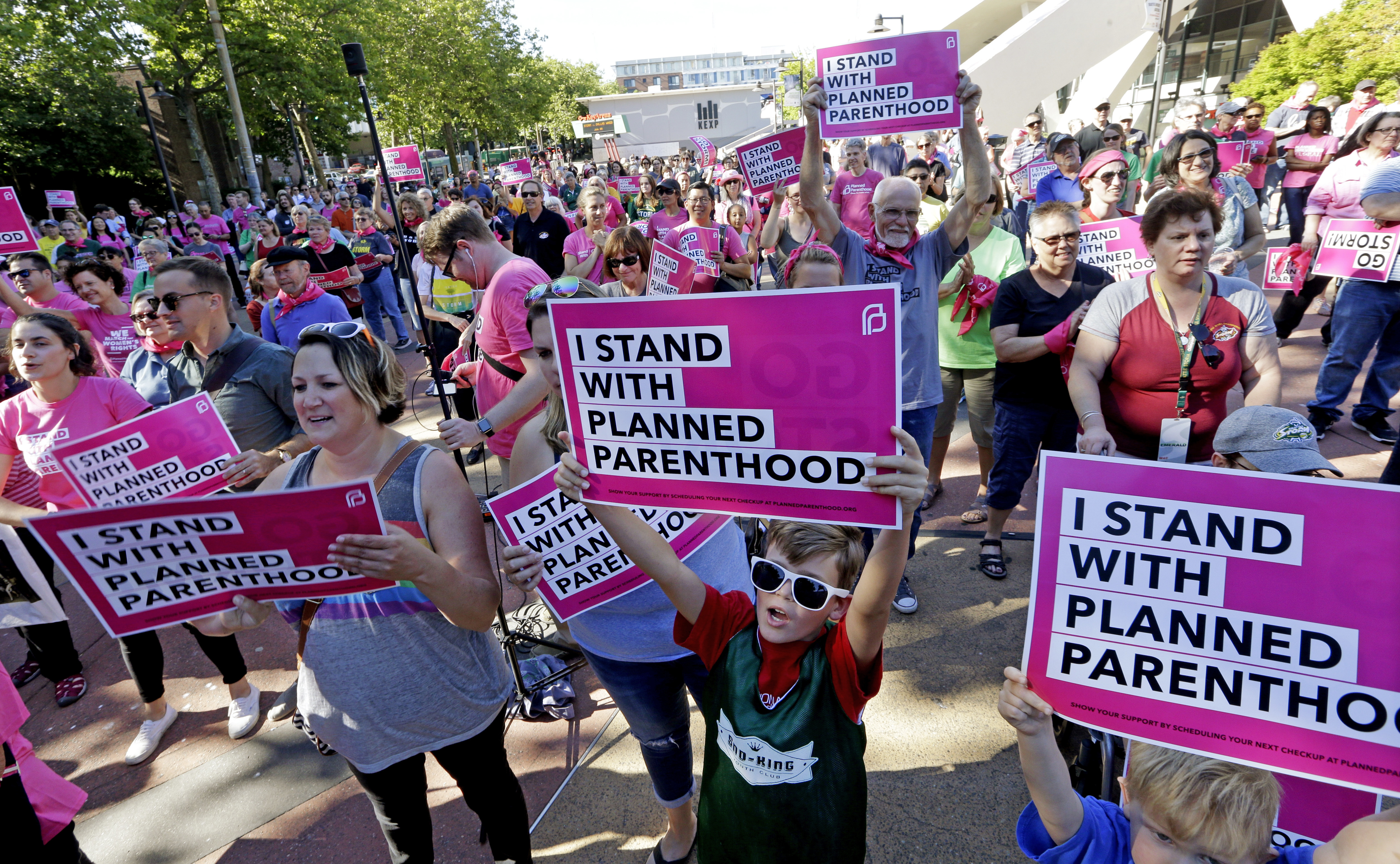 Seattle Storm fans and others cheer at a rally in support of Planned Parenthood before a WNBA basketball game between the Storm and the Chicago Sky on Tuesday, July 18, 2017, in Seattle. (AP Photo/Elaine Thompson)