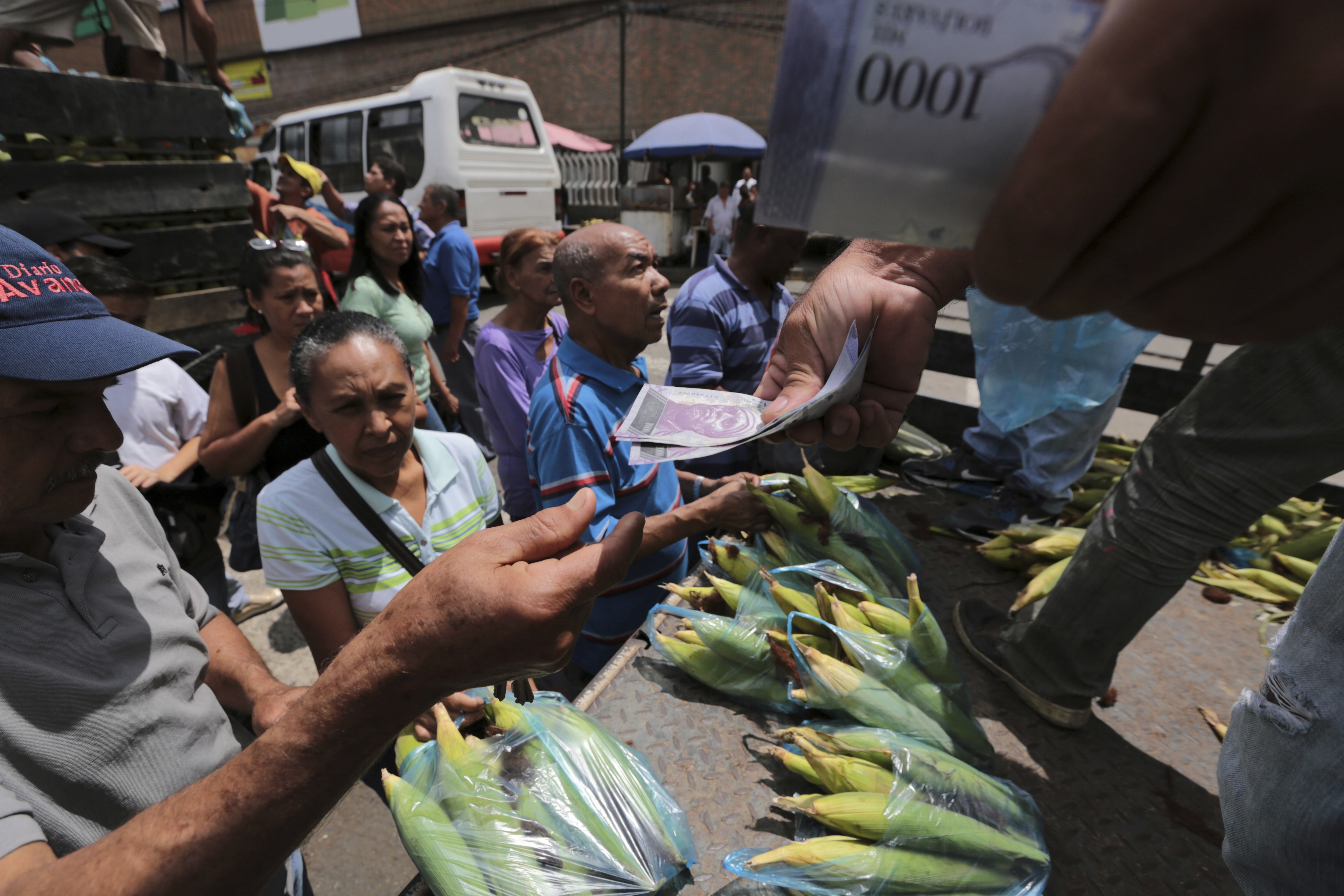 Venezuelans already struggling to find food, medicine and other basic necessities have a new headache to worry about: shortages of cash. (CREDIT: Fernando Llano/AP Photo)