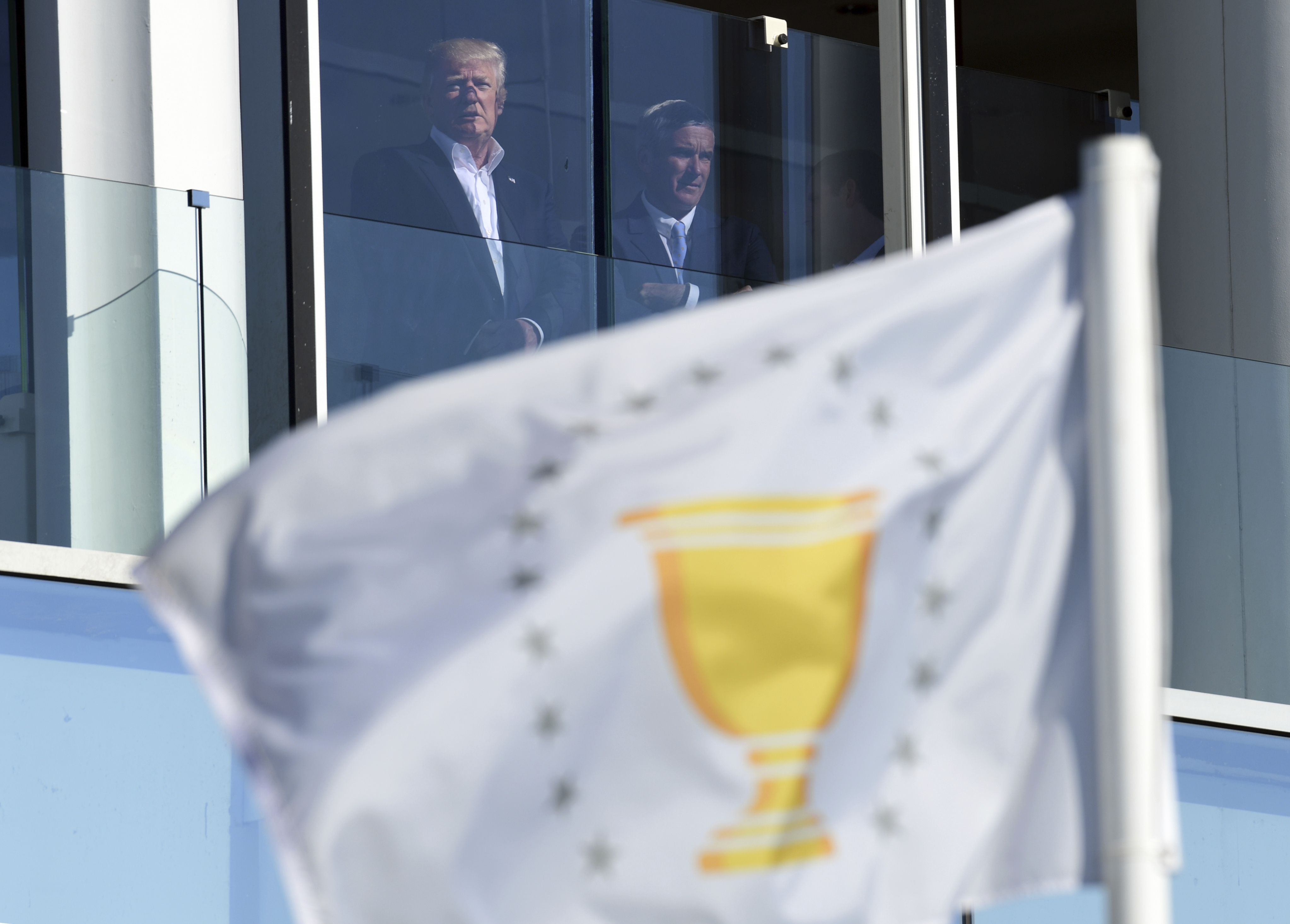 President Donald Trump watches the Presidents Cup golf tournament at the Liberty National Golf Course in Jersey City, N.J., Sunday, Oct. 1, 2017. (AP Photo/Susan Walsh)
