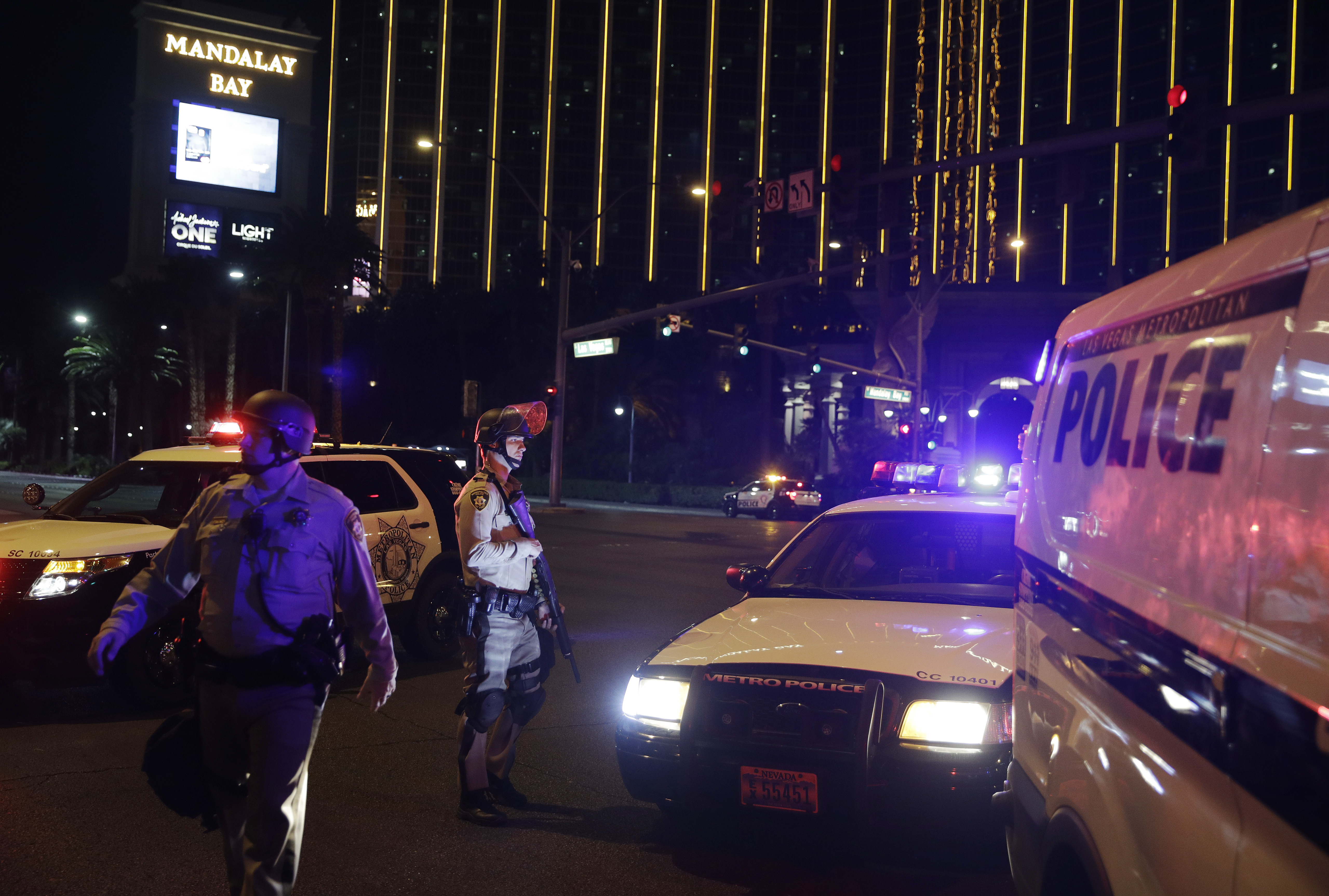 Police officers stand along the Las Vegas Strip outside the Mandalay Bay resort and casino during a deadly shooting near the casino, Sunday, Oct. 1, 2017, in Las Vegas. CREDIT: AP Photo/John Locher