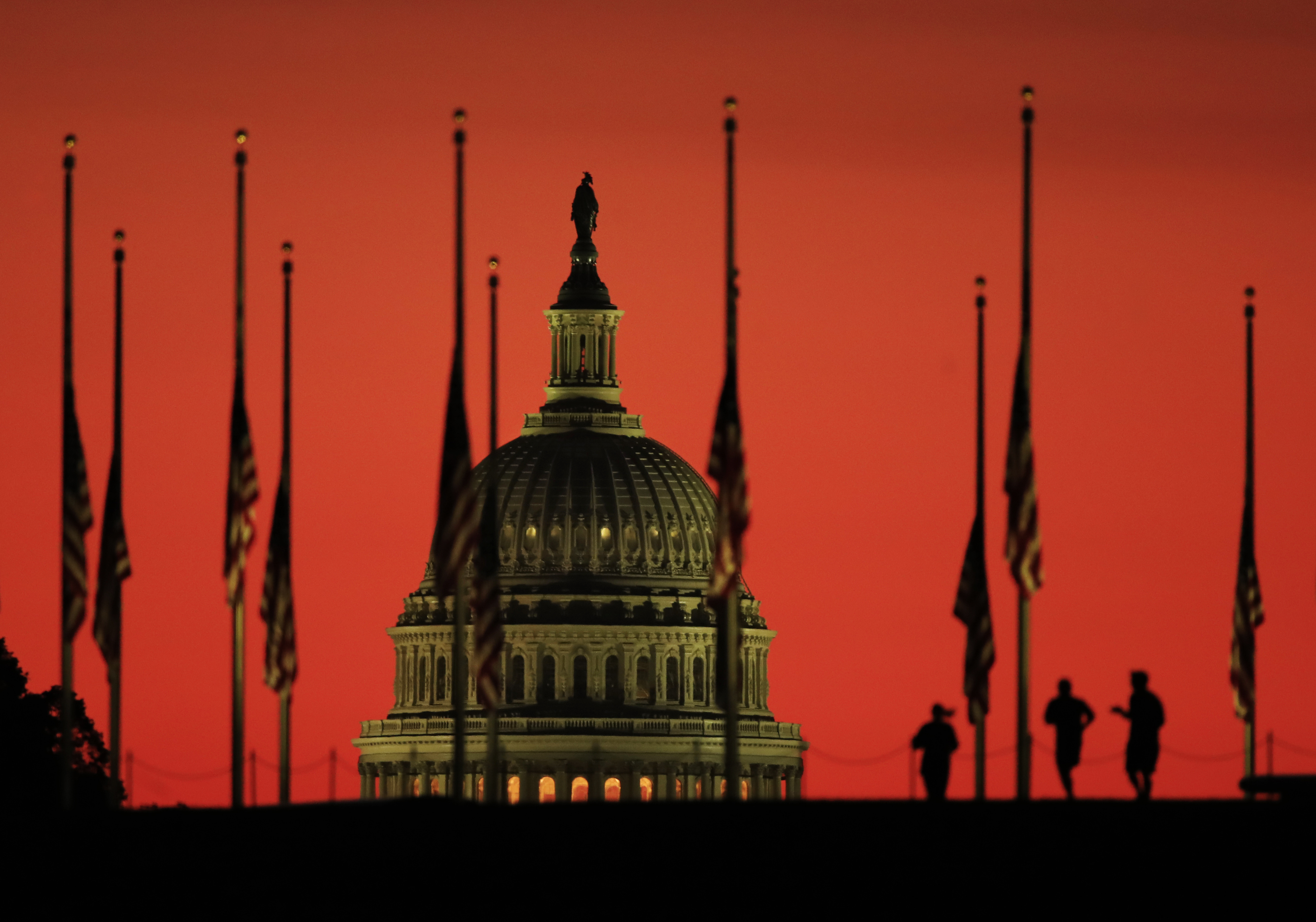U.S. Capitol dome and flags at half-staff in honor of the victims killed in the Las Vegas shooting. CREDIT: AP Photo/Manuel Balce Ceneta