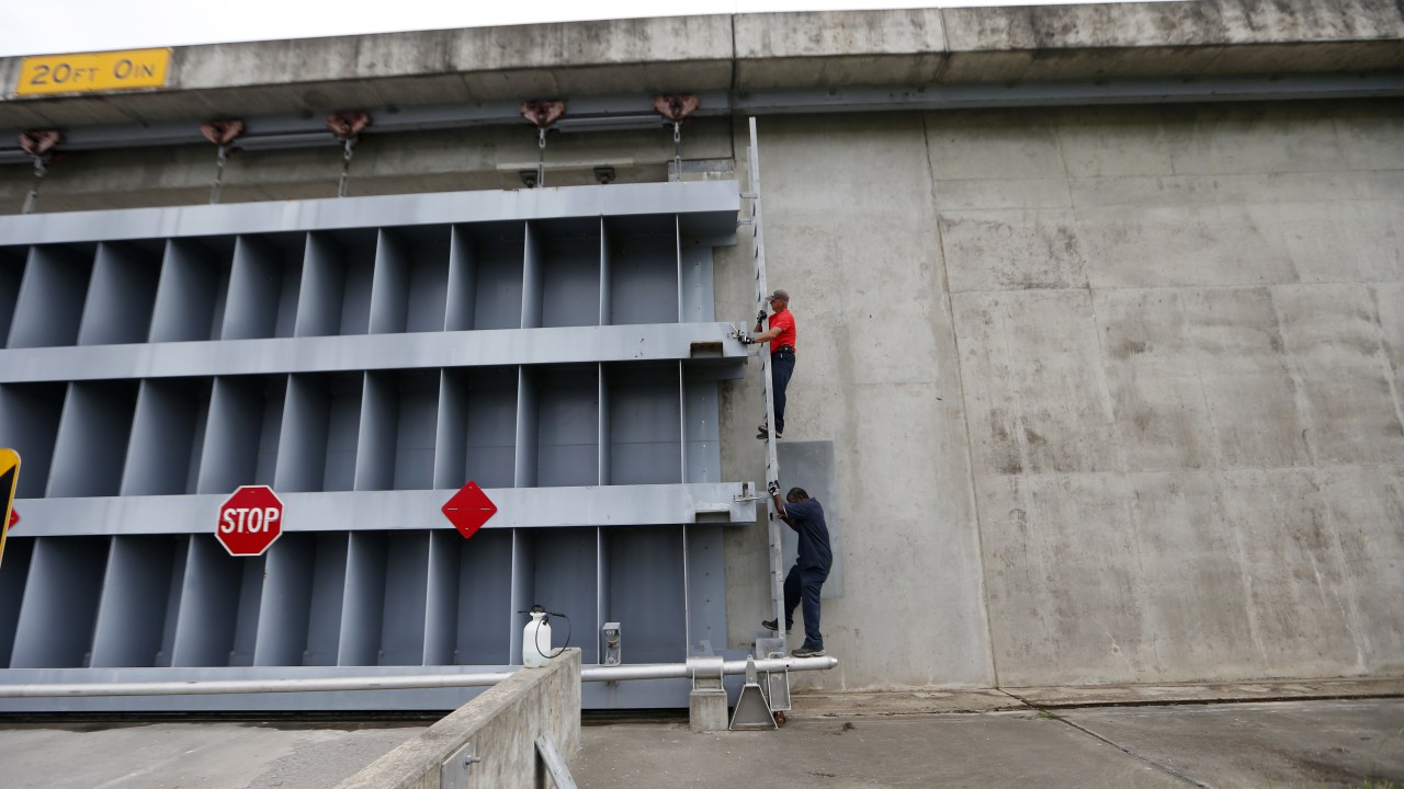 Workers close the floodgate separating St. Bernard Parish from the East Bank of Plaquemines Parish, in Violet, La., in preparation for Hurricane Nate, expected to make landfall on the Gulf Coast, Saturday, Oct. 7, 2017. Credit: AP Photo/Gerald Herbert