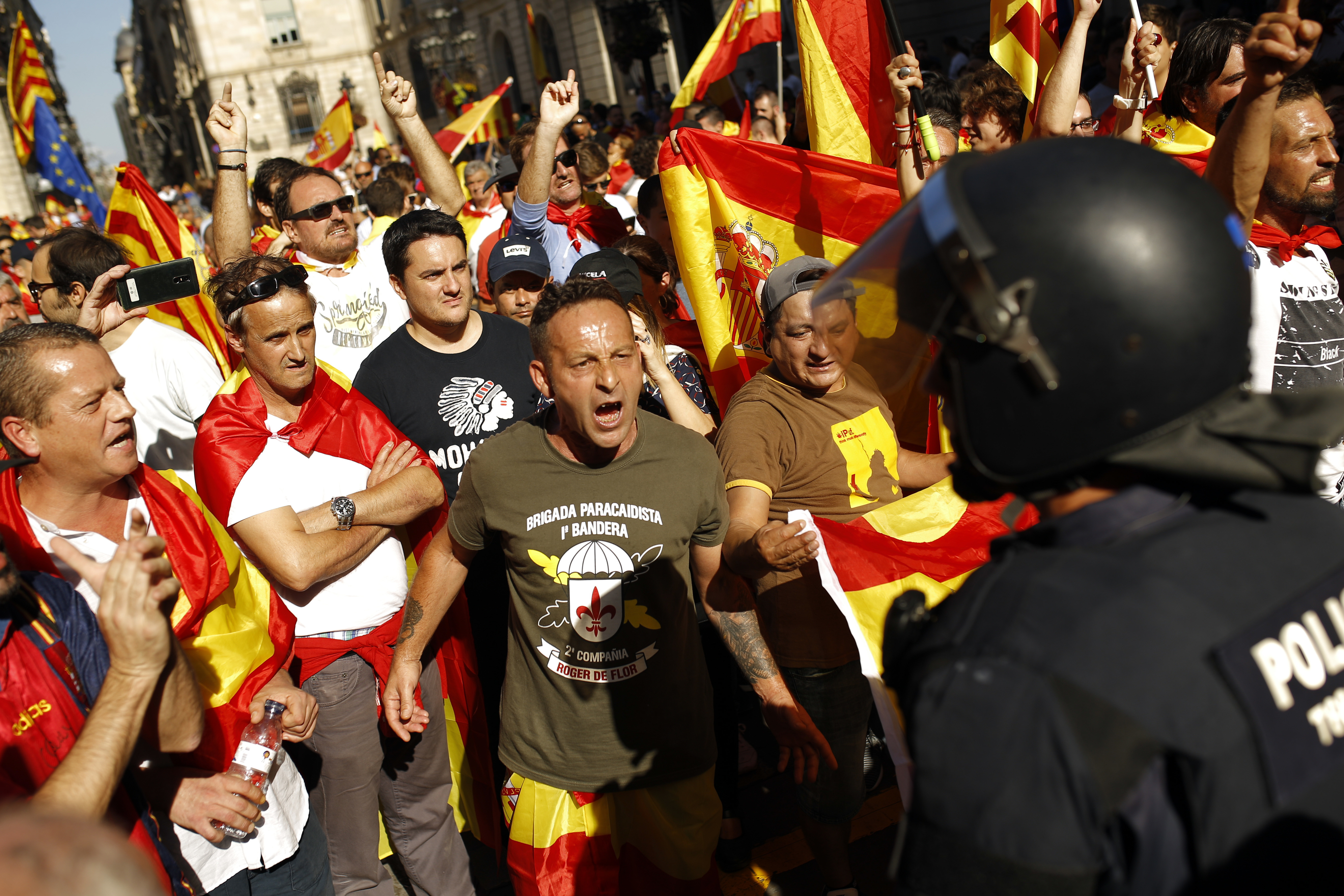 Anti-secession demonstrators challenge Catalan Mossos d'Esquadra regional police officers at the end of a march in downtown Barcelona, Spain on Sunday. CREDIT: AP Photo/Francisco Seco
