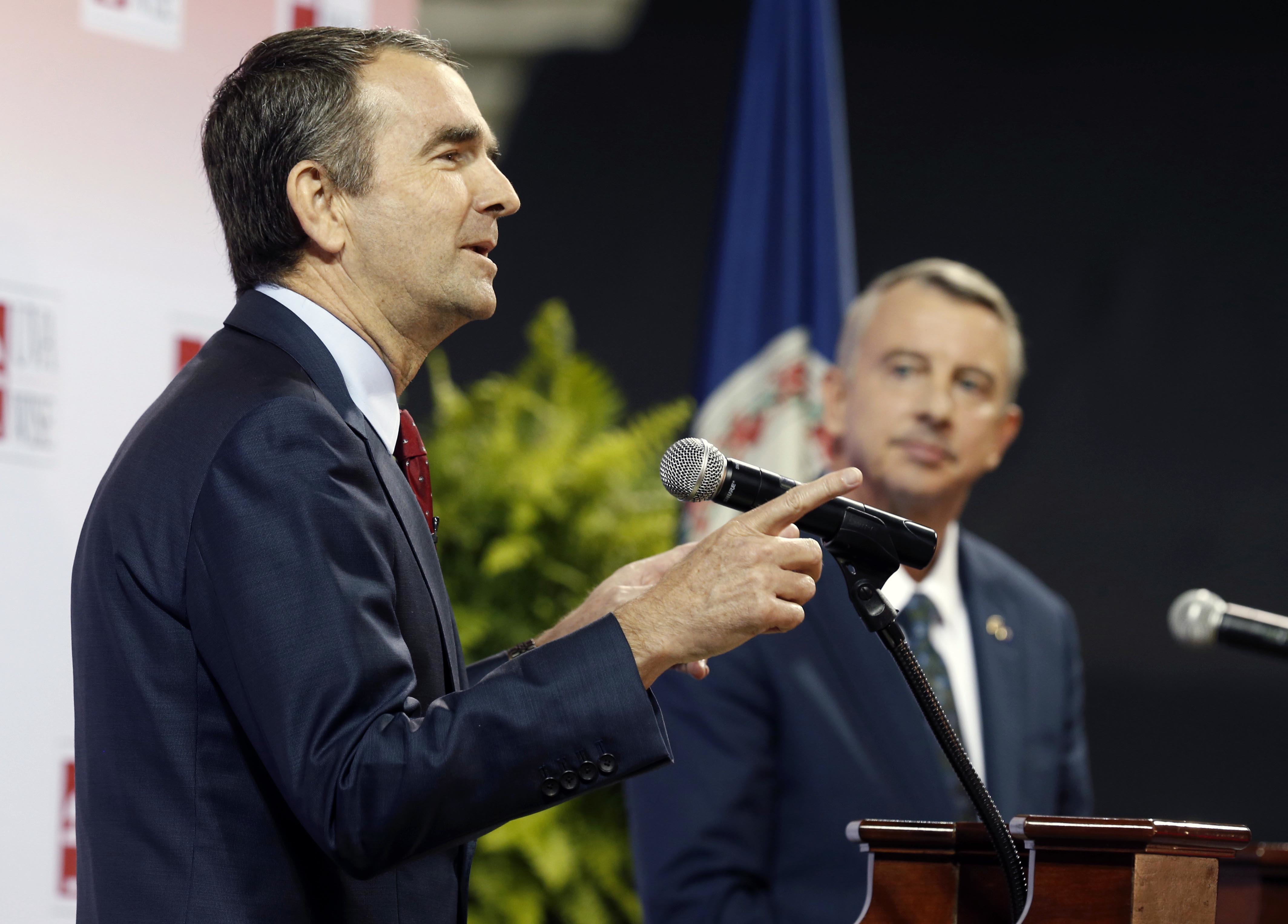 Democratic candidate for governor, Lt. Gov. Ralph Northam, left, gestures during a debate with Republican challenger Ed Gillespie at the University of Virginia-Wise in Wise, Va., Monday, Oct. 9, 2017. CREDIT: AP Photo/Steve Helber