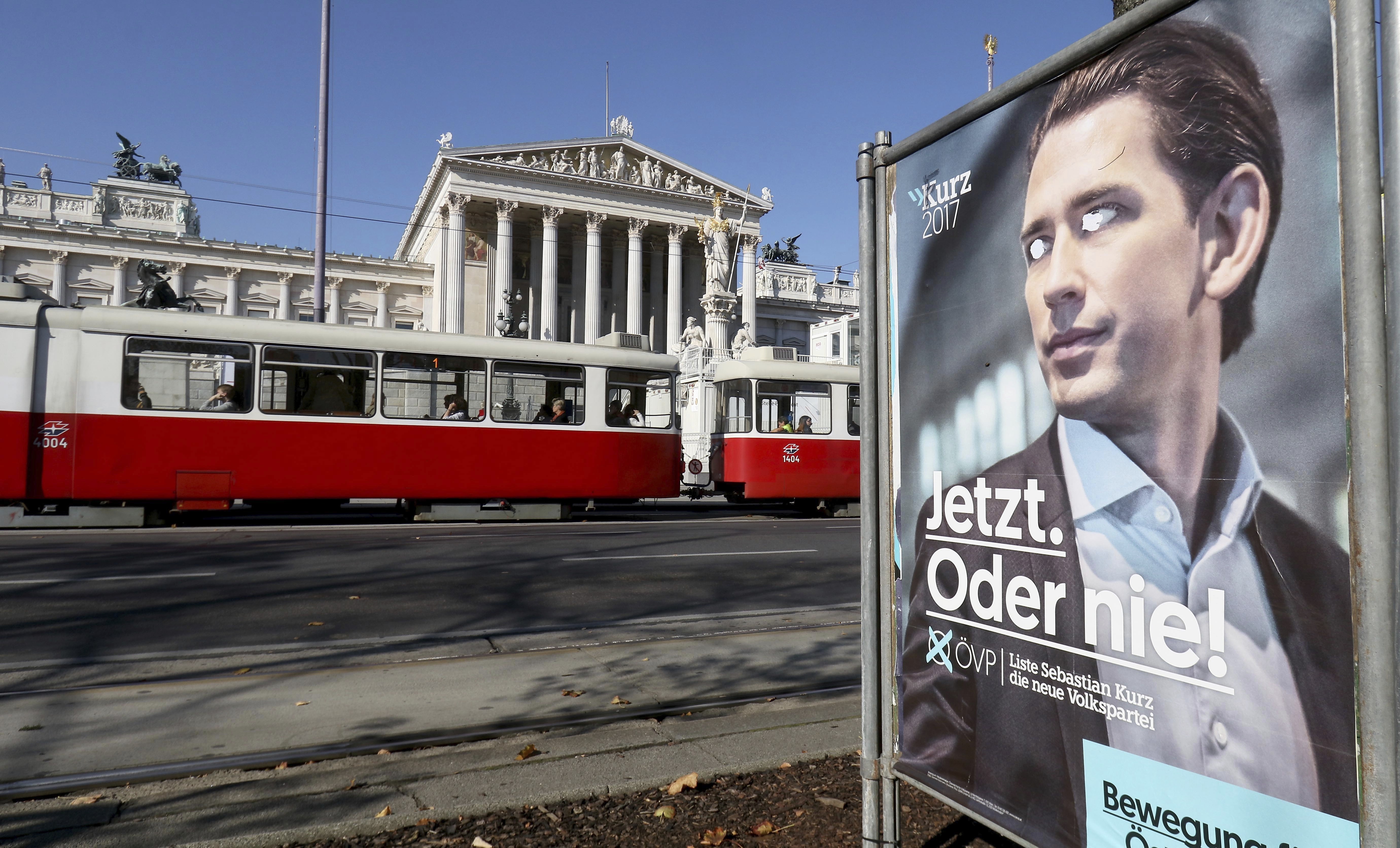 An election poster of the conservative Austrian People's Party, stands in front of the parliament in Vienna, Austria, Monday, Oct. 16, 2017. Hundreds of thousands of ballots must still be counted in Austria's general elections, but the tally is not likely to substantially change results that have put 31-year old Foreign Minister Sebastian Kurz on track to become Europe's youngest leader. CREDIT: Ronald Zak/AP Photos.
