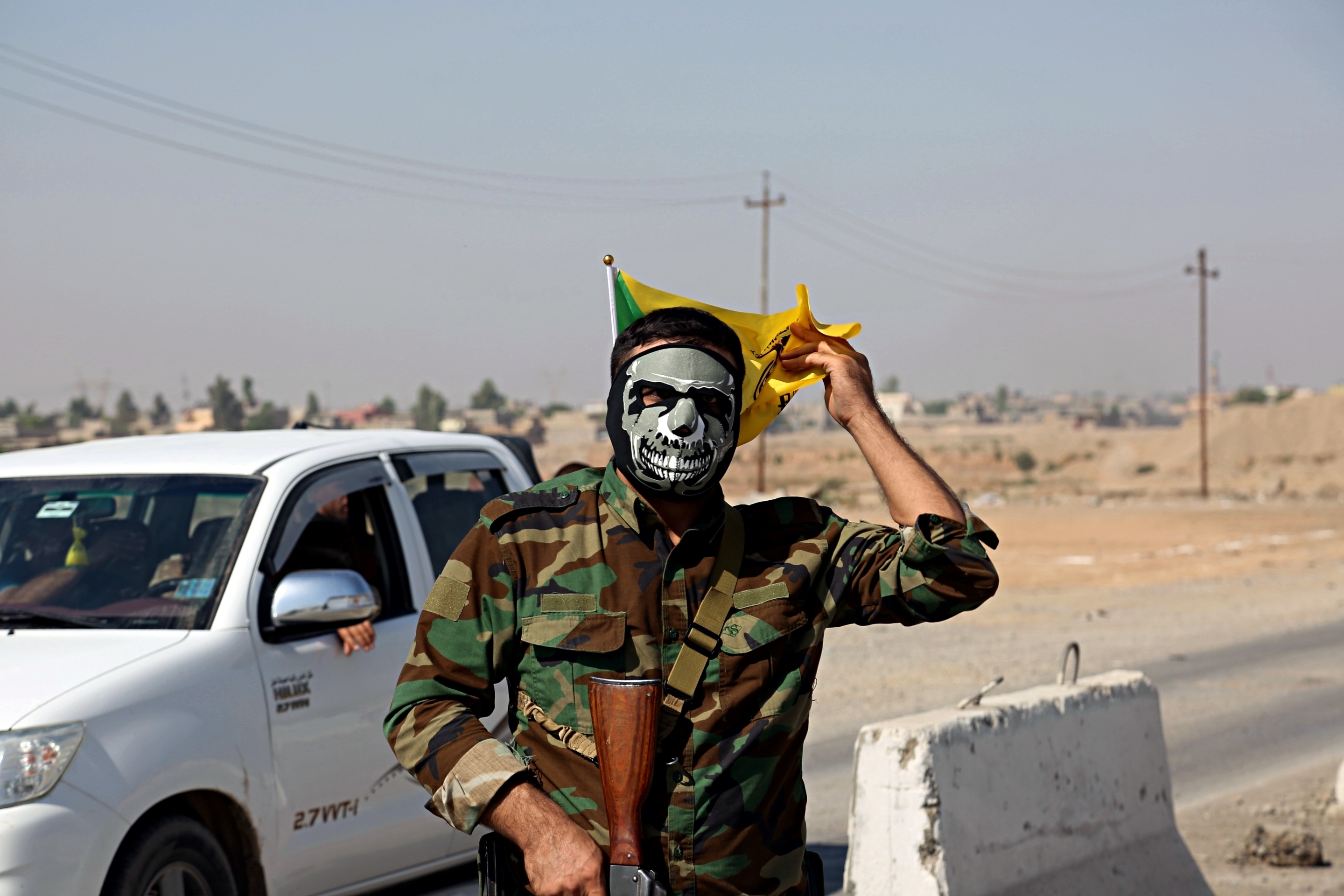 A fighter with Popular Mobilization Forces stands guard in Tuz Khormato, that was evacuated by Kurdish security forces, 130 miles north of Baghdad, Iraq, on Oct. 16, 2017. Two weeks after fighting together against ISIS, Iraqi forces pushed their Kurdish allies out of the disputed city of Kirkuk, seizing oil fields and other facilities amid soaring tensions over last month's Kurdish vote for independence. CREDIT: AP Photo.