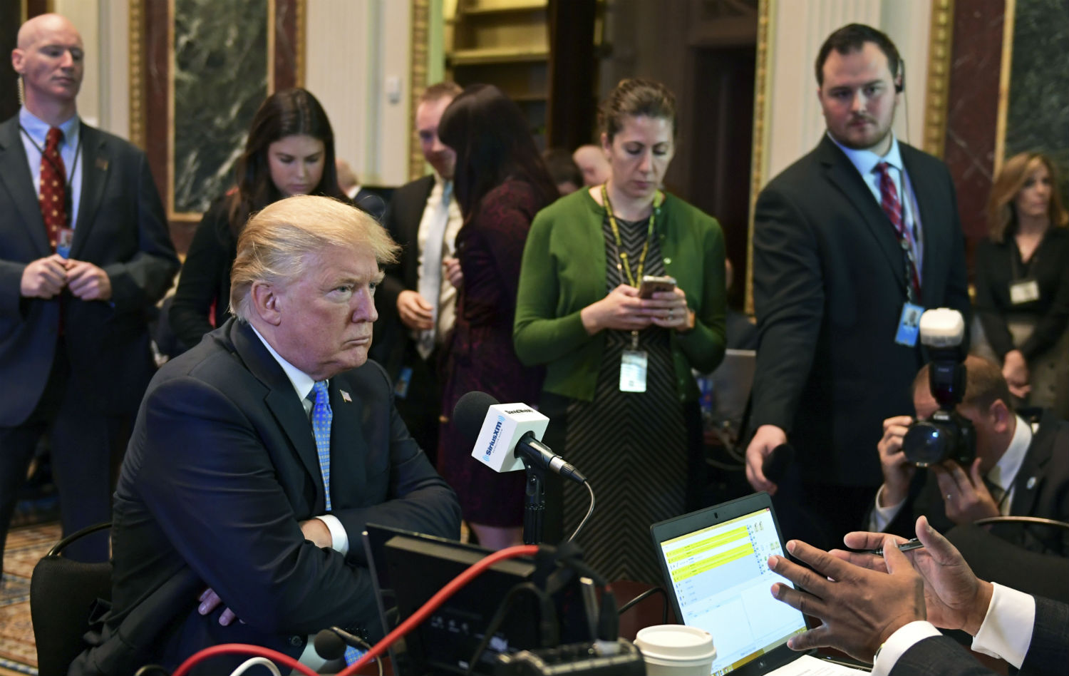 President Trump sits for a radio interview in the Eisenhower Executive Office Building in the White House complex on Tuesday. (CREDIT: AP Photo/Susan Walsh)