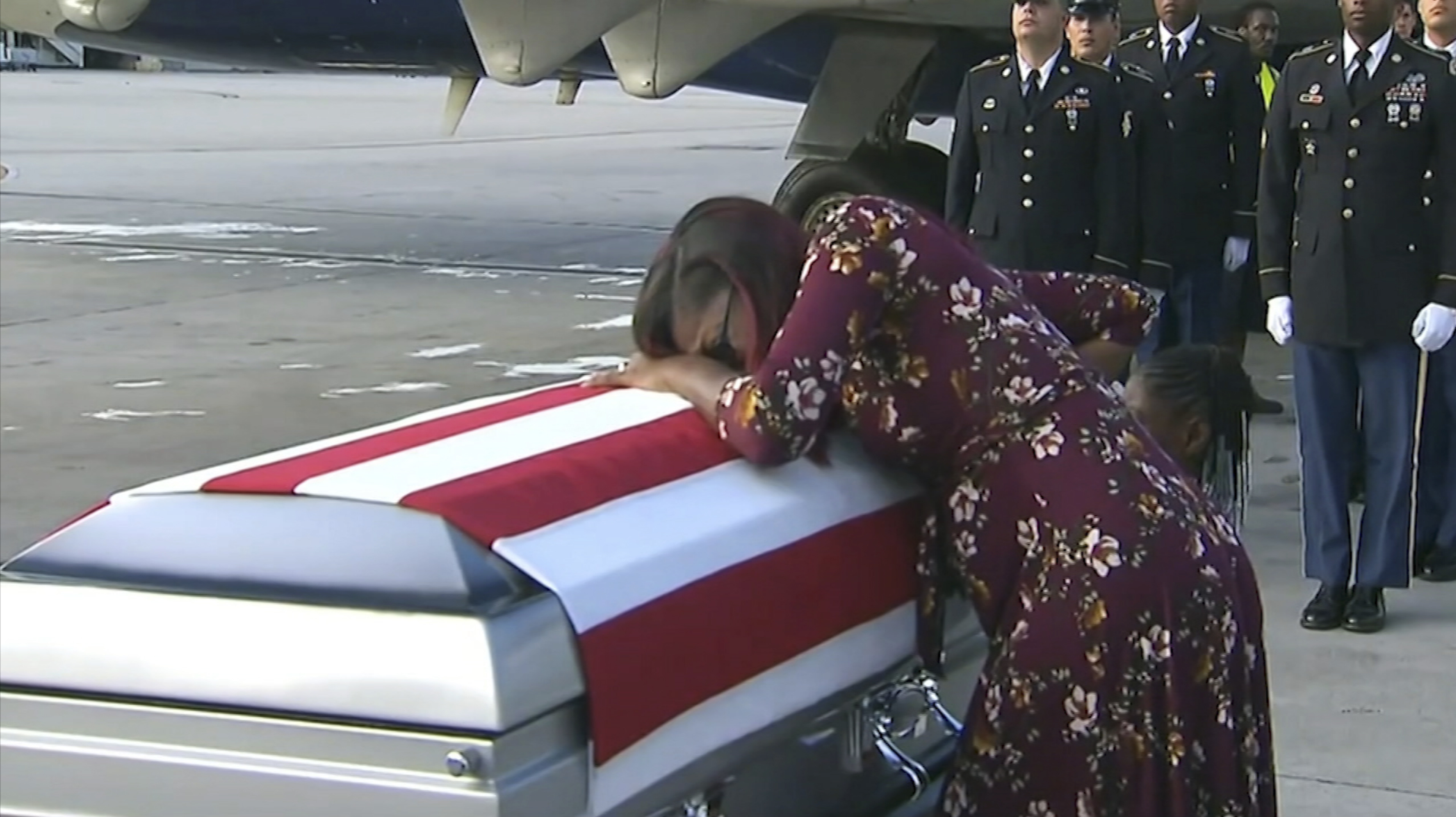 In this Tuesday, Oct. 17, 2017, frame from video, Myeshia Johnson cries over the casket of her husband, Sgt. La David Johnson, who was killed in an ambush in Niger, upon his body's arrival in Miami. CREDIT: WPLG via AP