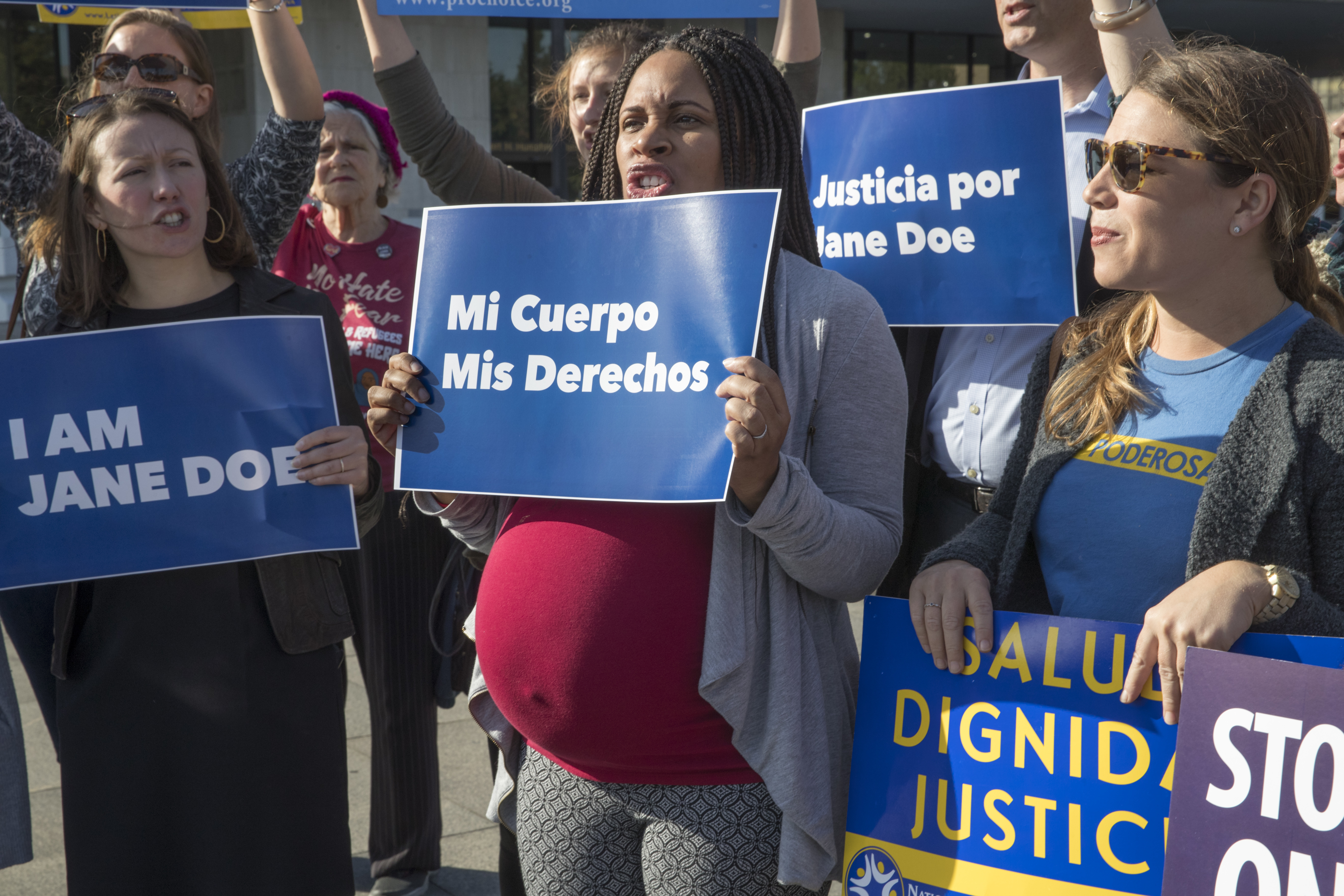 Activists with Planned Parenthood demonstrate in support of a pregnant 17-year-old being held in a Texas facility for unaccompanied immigrant children to obtain an abortion, outside of the Department of Health and Human Services in Washington, Friday, Oct. 20, 2017. CREDIT: AP Photo/J. Scott Applewhite