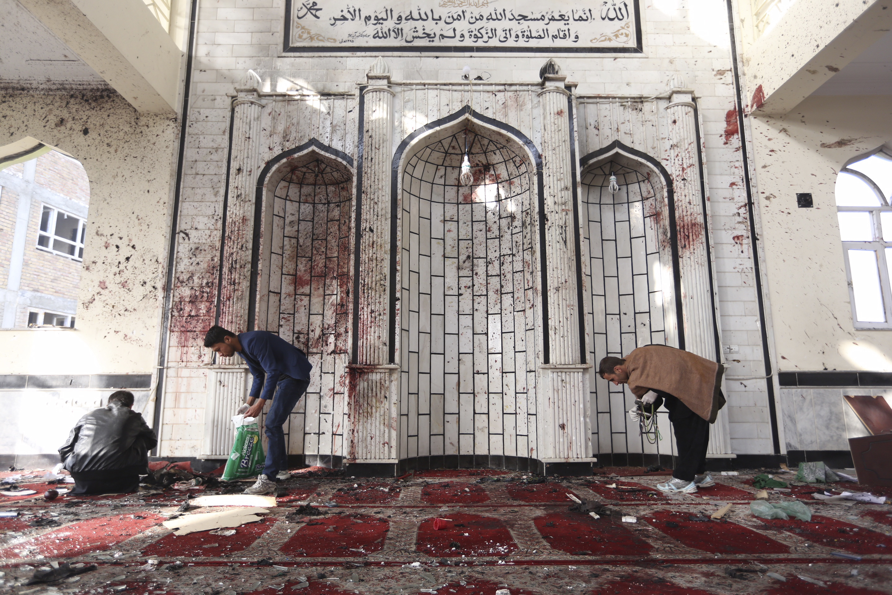 Afghans inspect a damaged mosque after a suicide attack. (AP Photo/Rahmat Gul)