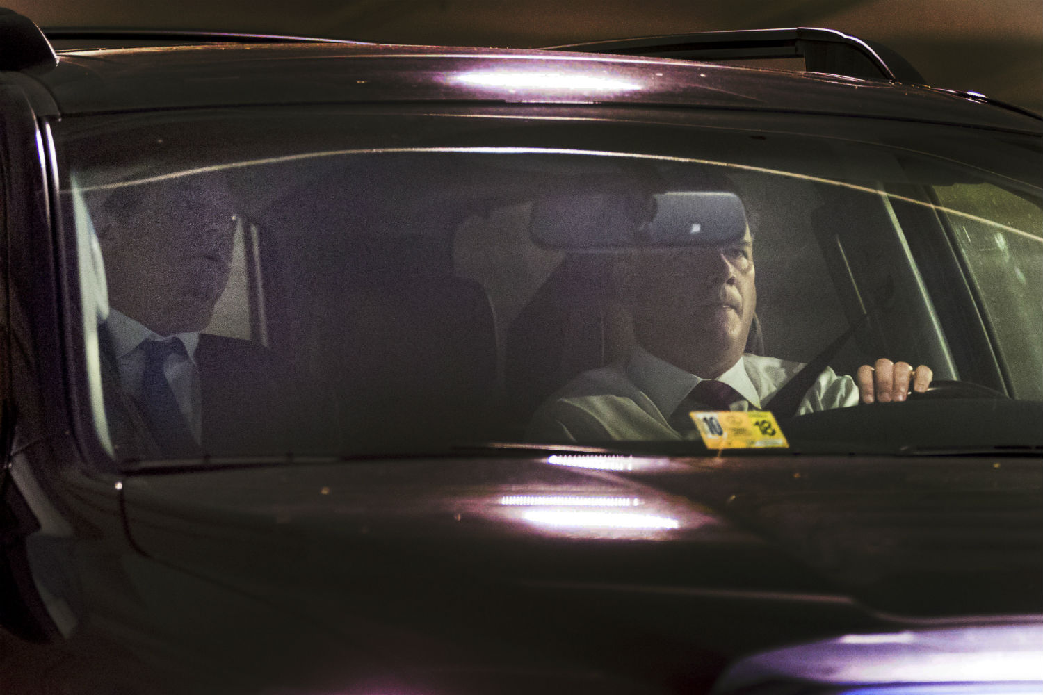 Former Trump Campaign Chairman Paul Manafort, left, leaves his home in Alexandria, Virginia, on Monday. Manafort, and a former business associate, Rick Gates, have been told to surrender to federal authorities Monday, according to reports and a person familiar with the matter. (CREDIT: AP Photo/Andrew Harnik)