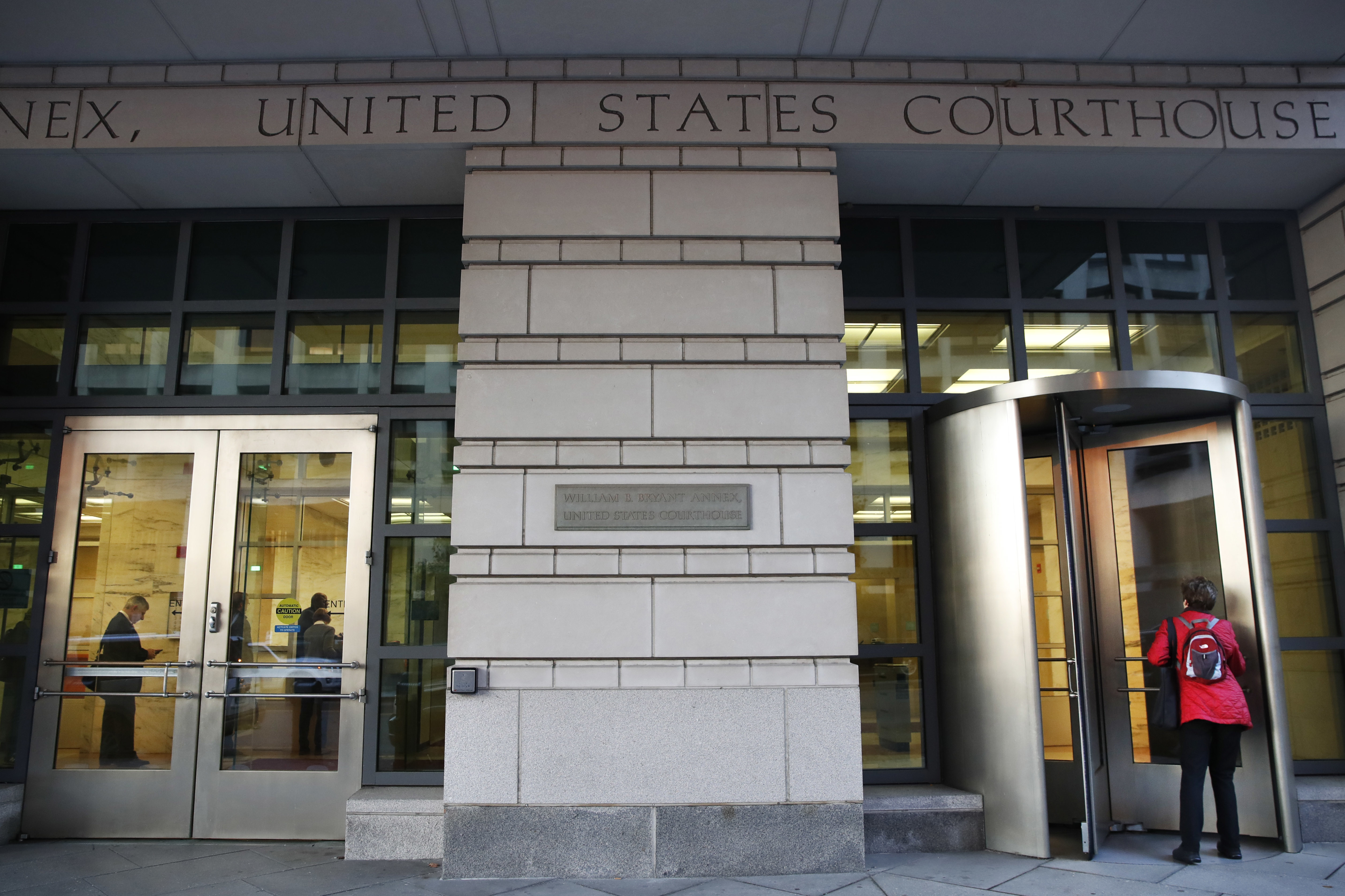 People enter the Federal Court, Monday, Oct. 30, 2017, in Washington. CREDIT: AP Photo/Jacquelyn Martin