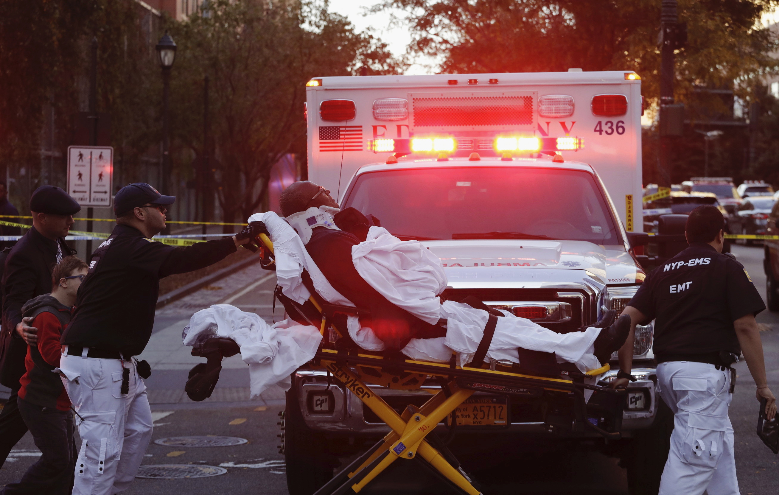 Emergency personnel transport a man on a stretcher after a motorist drove onto a busy bicycle path near the World Trade Center memorial and struck several people Tuesday, Oct. 31, 2017, in New York. (AP Photo/Mark Lennihan)