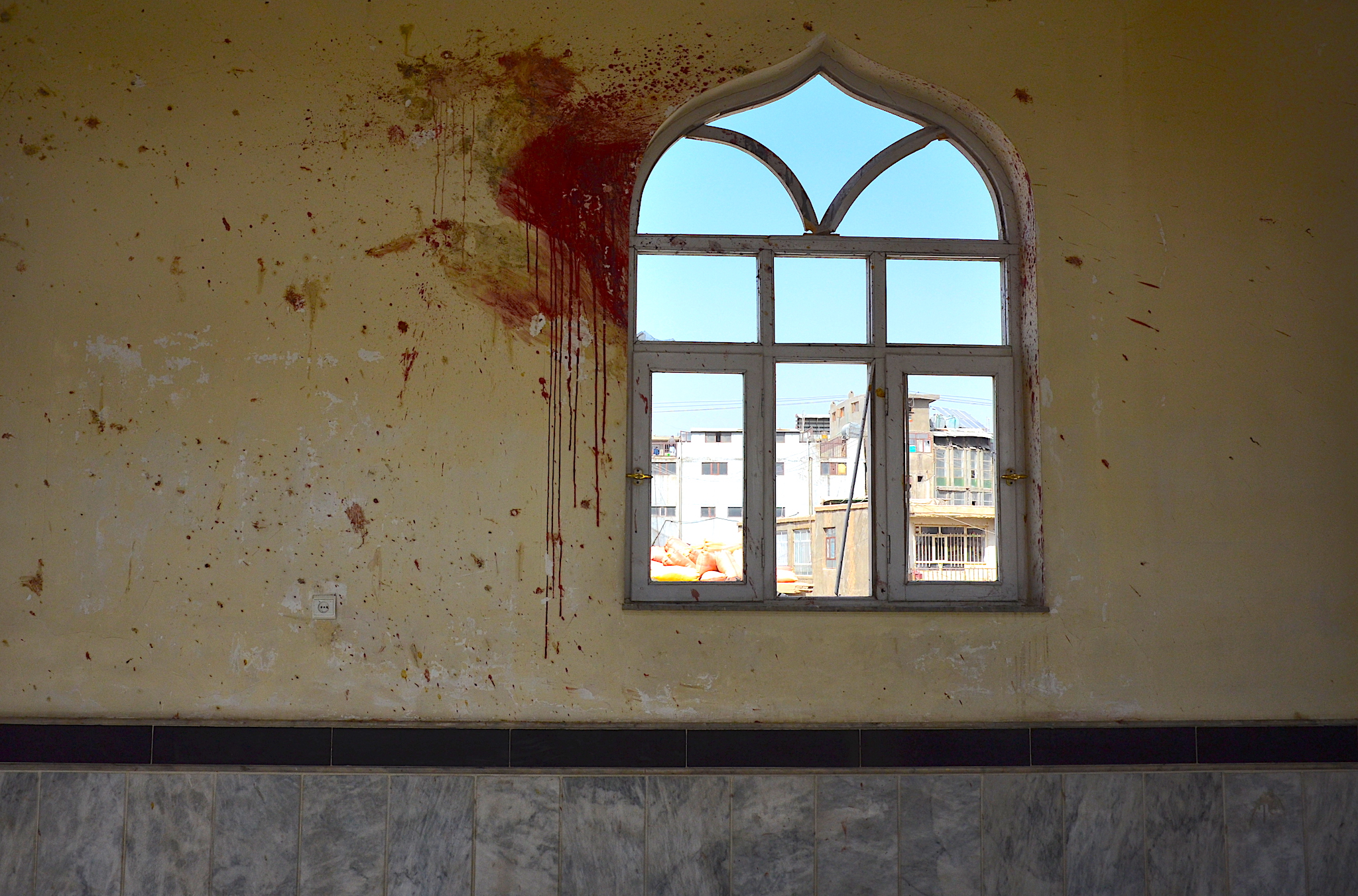 The walls of the Imam Zaman Mosque spattered in blood. (Ali M. Latifi)