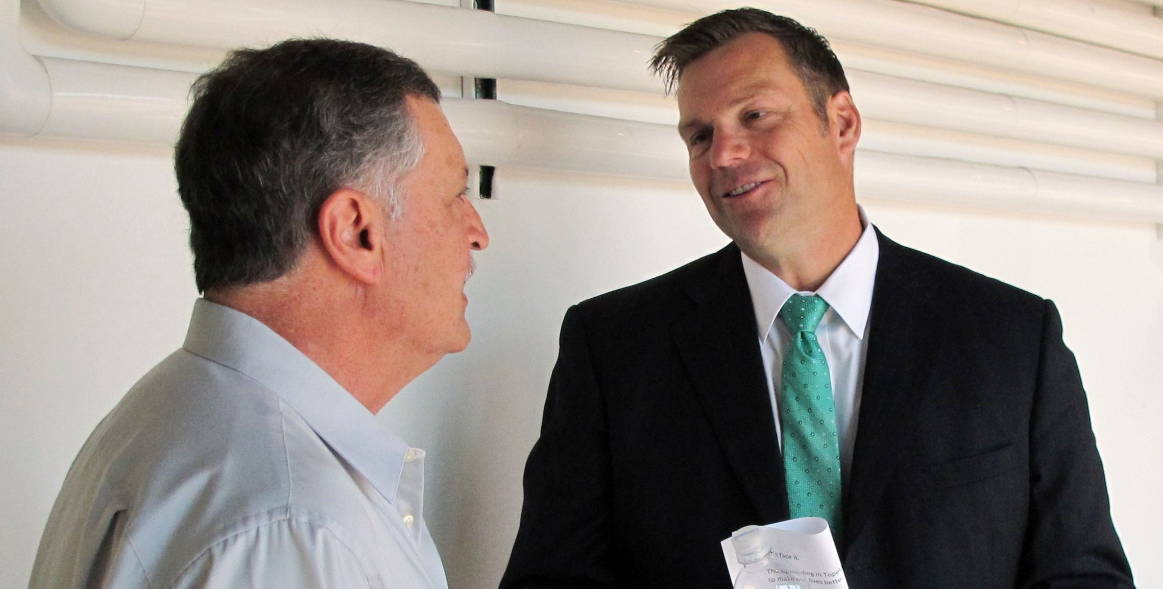 Kansas Secretary of State Kris Kobach, right, before his announcement that he's running for governor, Thursday, June 8, 2017. CREDIT: AP Photo/John Hanna