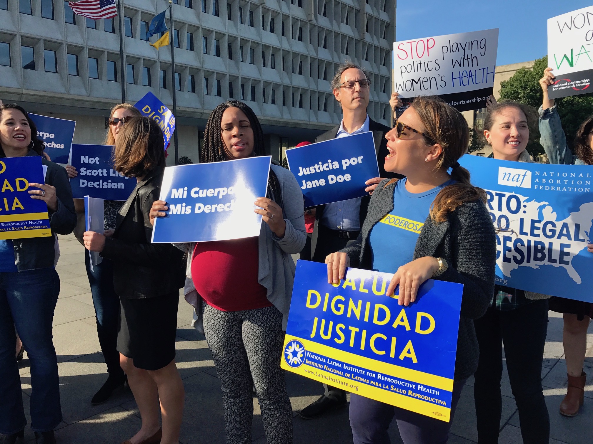 Protesters, in front of the Health and Human Services building on Friday, speak out against the Trump administration’s decision to bar an undocumented teenager from getting an abortion. (CREDIT: Casey Quinlan)