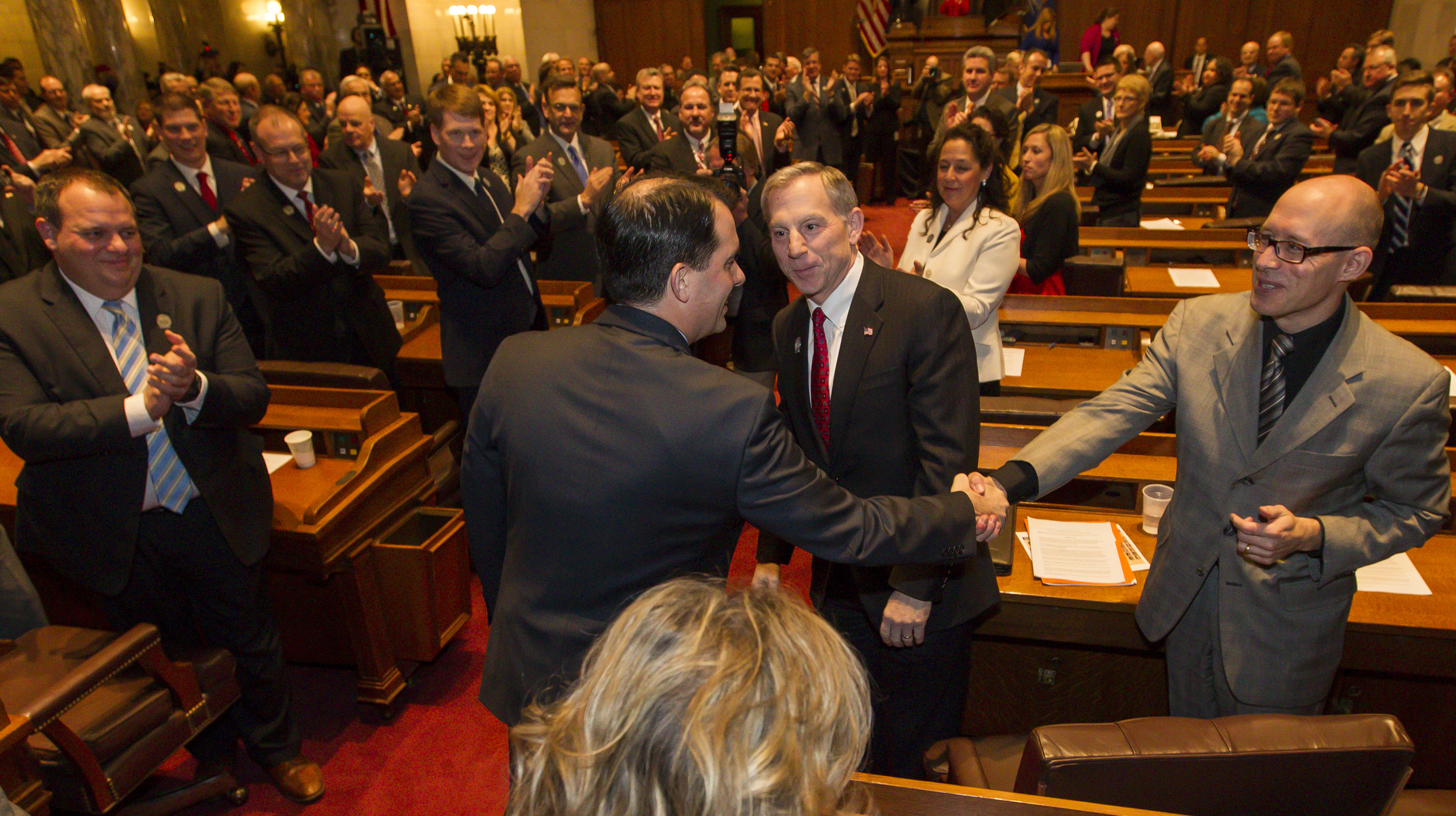 Wisconsin Gov. Scott Walker (R) shakes hands with Rep. Scott Allen (R). CREDIT: AP Photo/Andy Manis