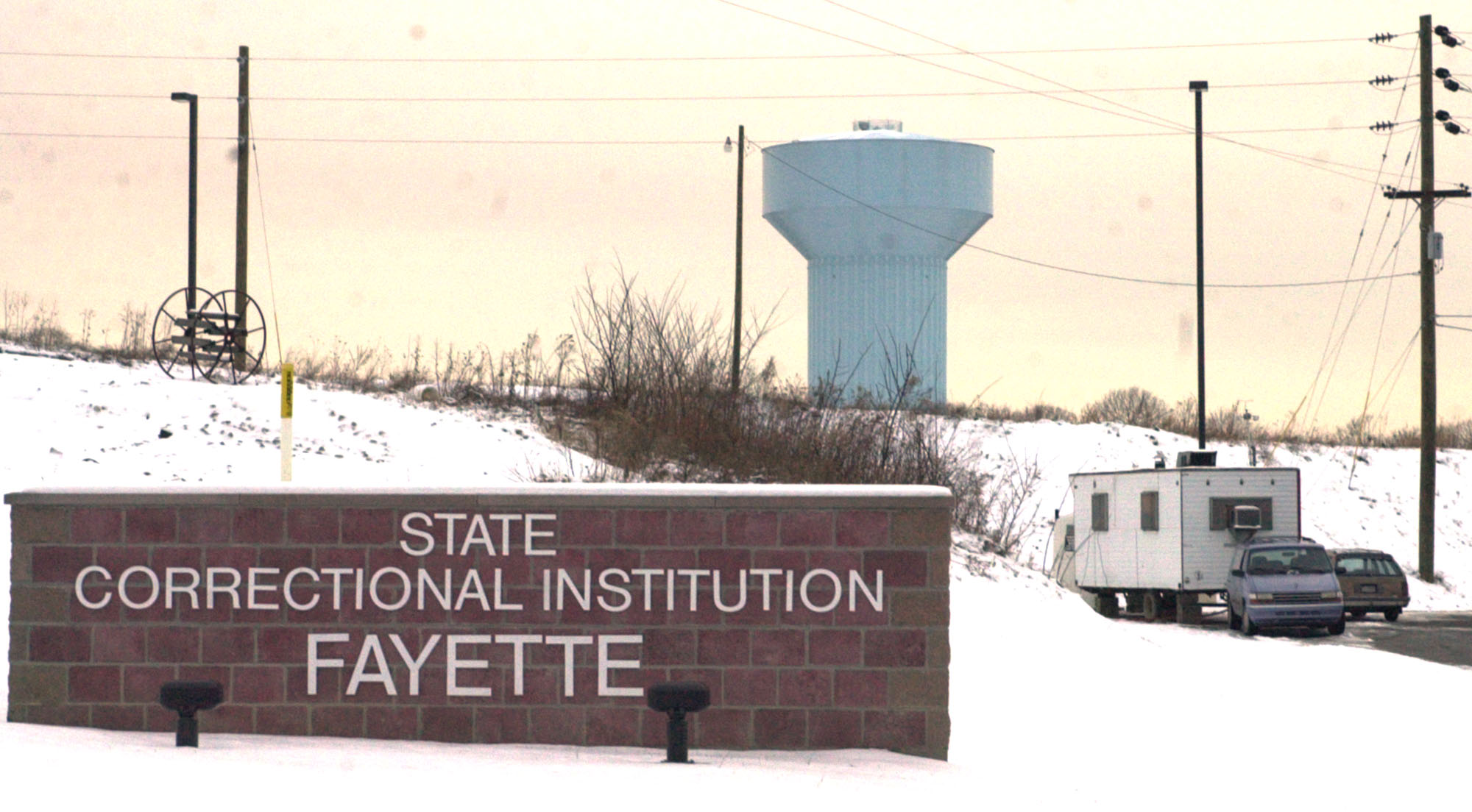A trailer sets in the entrance driveway to the Pennsylvania State Correctional Institute Fayette prison site (Credit: AP Photo/Keith Srakocic)