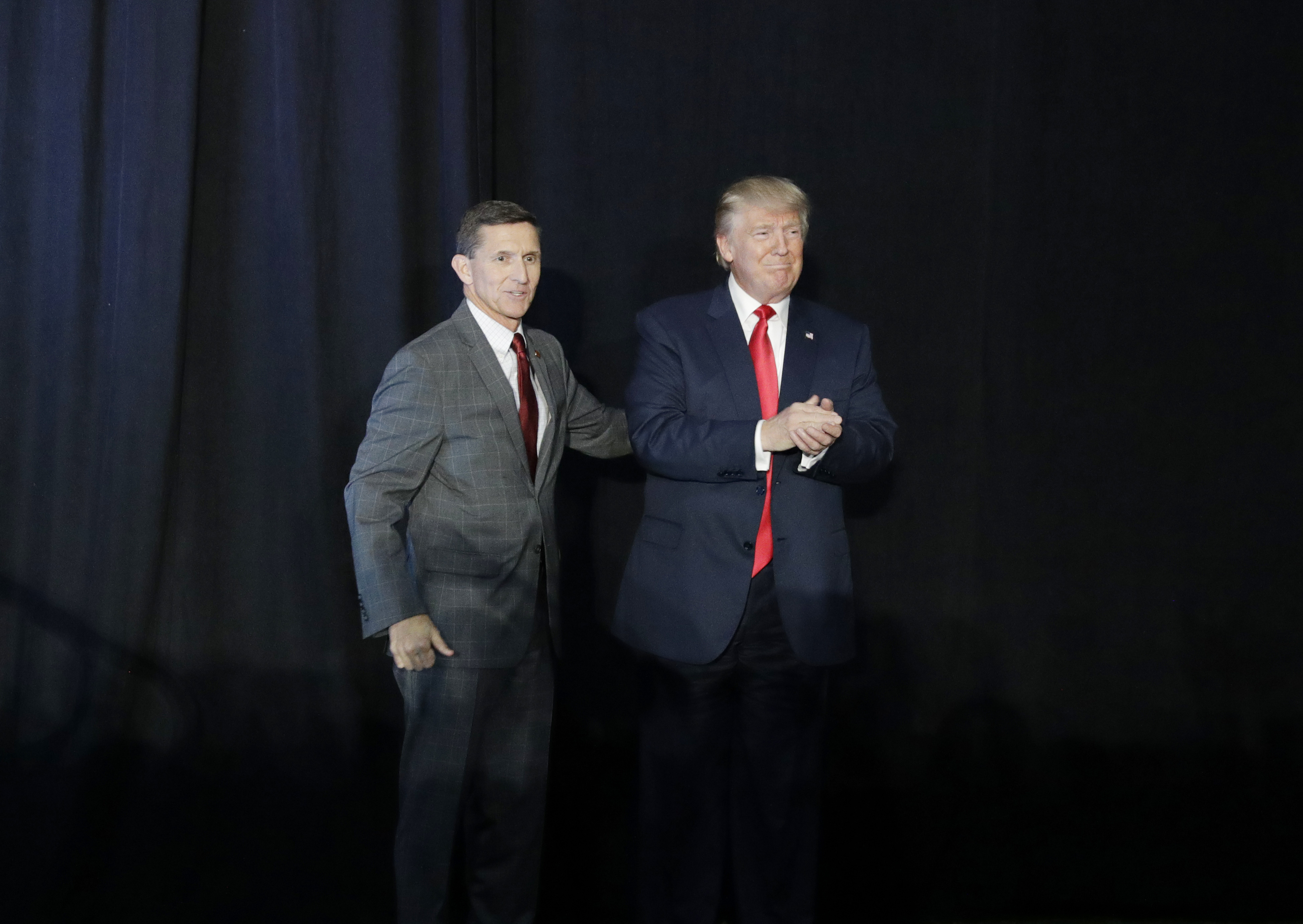 Retired Gen. Michael Flynn, left, introduces Republican presidential candidate Donald Trump at a campaign rally, Thursday, Sept. 29, 2016, in Bedford, N.H. CREDIT: John Locher/AP Photo.