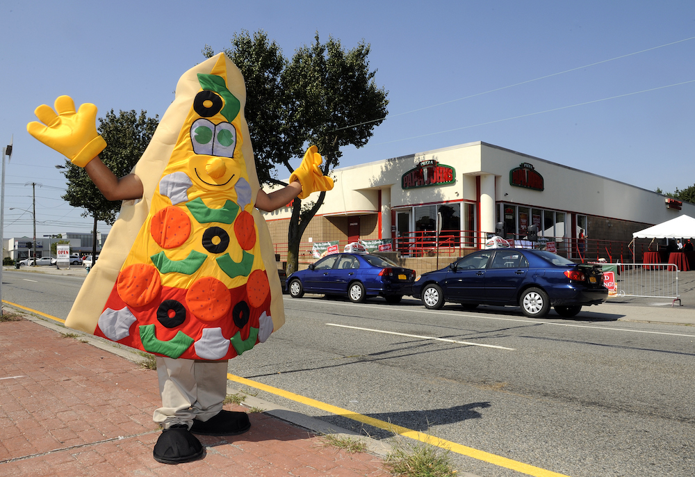 This inflatable slice of Papa John's "pizza" probably tastes as good as the real thing. (Credit: AP Images)
